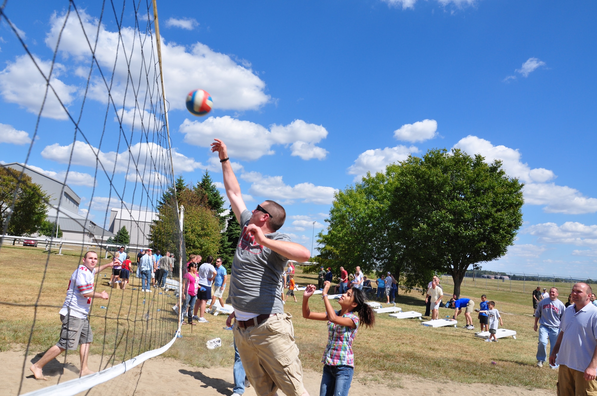 WRIGHT-PATTERSON AIR FORCE BASE, Ohio – Senior Airman Mikhail Berlin, 445th Airlift Wing Public Affairs photographer, won the 2010 Air Force Reserve Command Media Contest, Outstanding New Photographer category. One of his photographs submitted for the contest included this one of Airmen and families playing volleyball on the sand court during the wing’s picnic Sept. 12 here at Bass Lake. (U.S. Air Force photo/Senior Airman Mikhail Berlin)