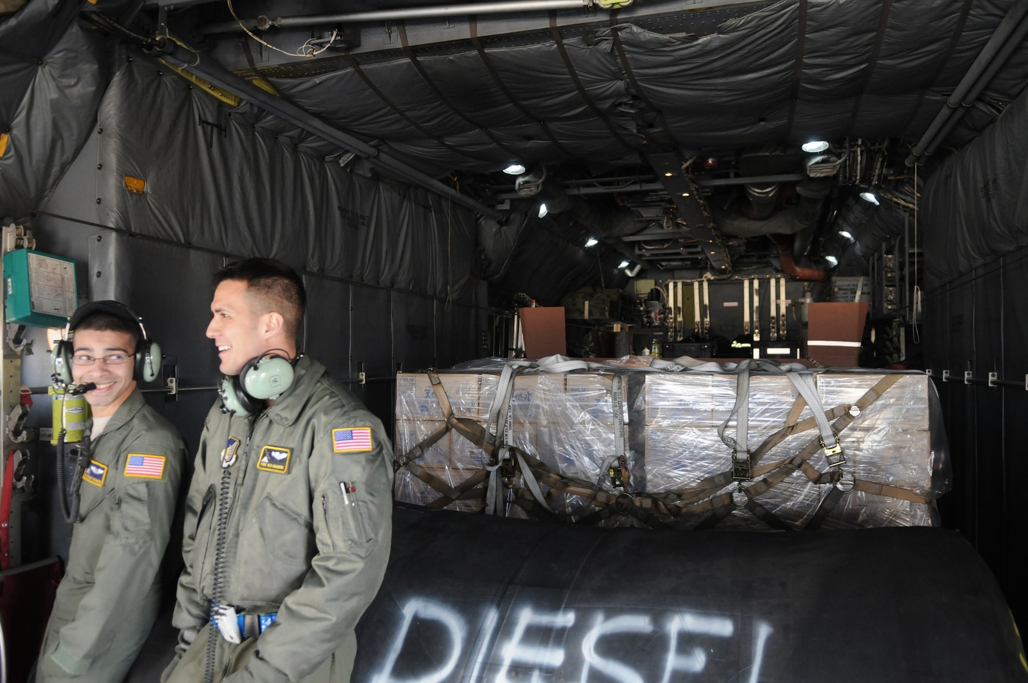 Airmen from the 730th Air Mobility Squadron load cargo on to a C-130 Hercules March 27, 2011, at Yokota Air Base, Japan. The supplies will be used in support for Operation Tomodachi. (U.S. Air Force photo/John D. Partlow)