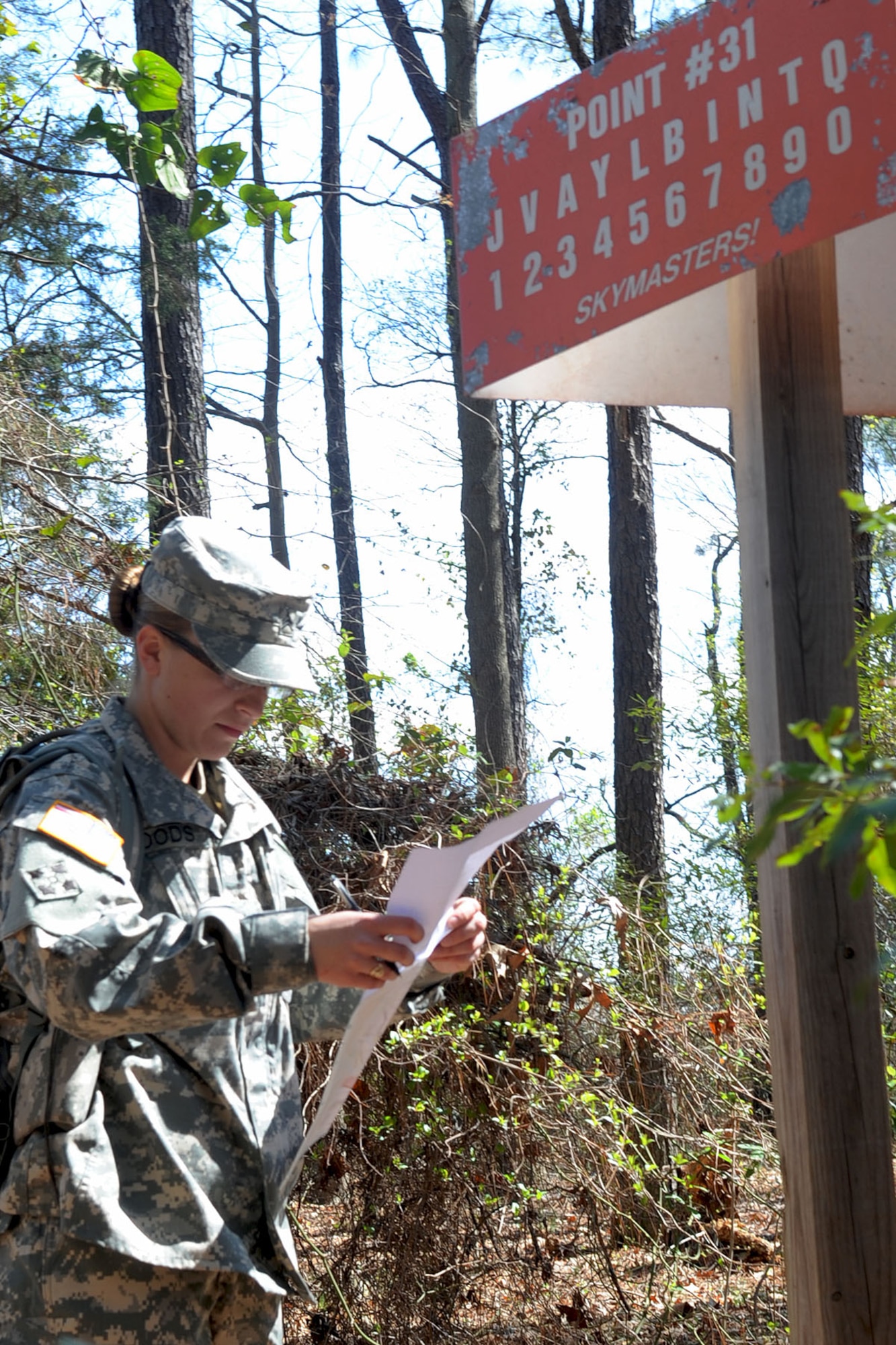 Army Sgt. Sarah Woods, Charlie Company, 2nd Battalion, 417th Regiment, drill sergeant candidate, coordinates her next point during the land navigation portion of the Best Warrior competition at Fort Eustis, Va., March 25, 2011. Soldiers from various bases tested their physical and mental capabilities in combat environments to strive fror the title of Best Warrior in their division. (U.S. Air Force photo by Staff Sgt. Ashley Hawkins/Released)