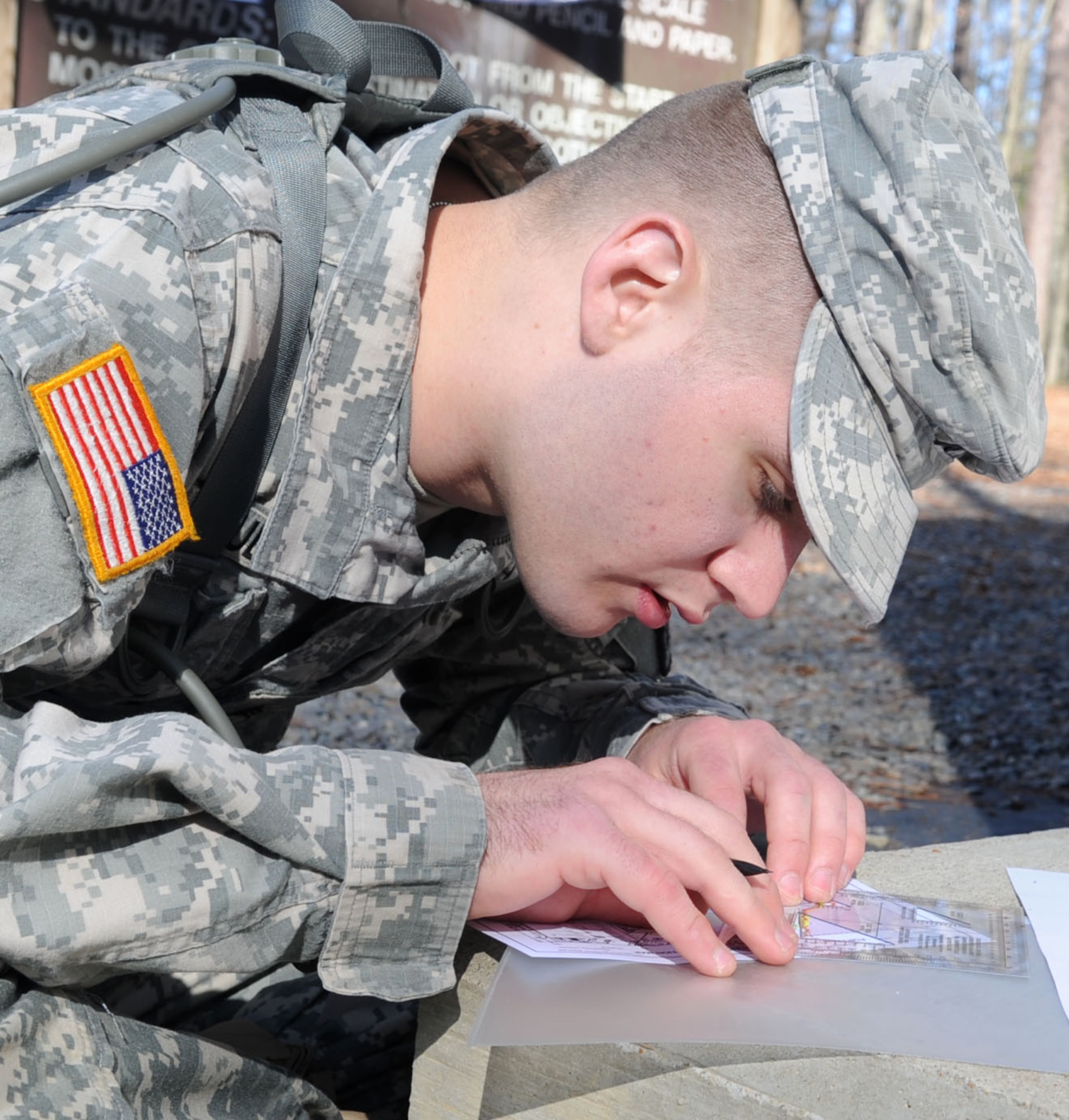 Army Sgt. Kenneth Gaudreau, drill sergeant candidate with 2nd Battalion, 317th Regiment, plots coordinates before the land navigation portion of the Best Warrior competition at Fort Eustis, Va., March 25, 2011. Soldiers from various bases tested their physical and mental capabilities in combat environments to strive for the title of Best Warrior in their division. (U.S. Air Force photo by Staff Sgt. Ashley Hawkins/Released)