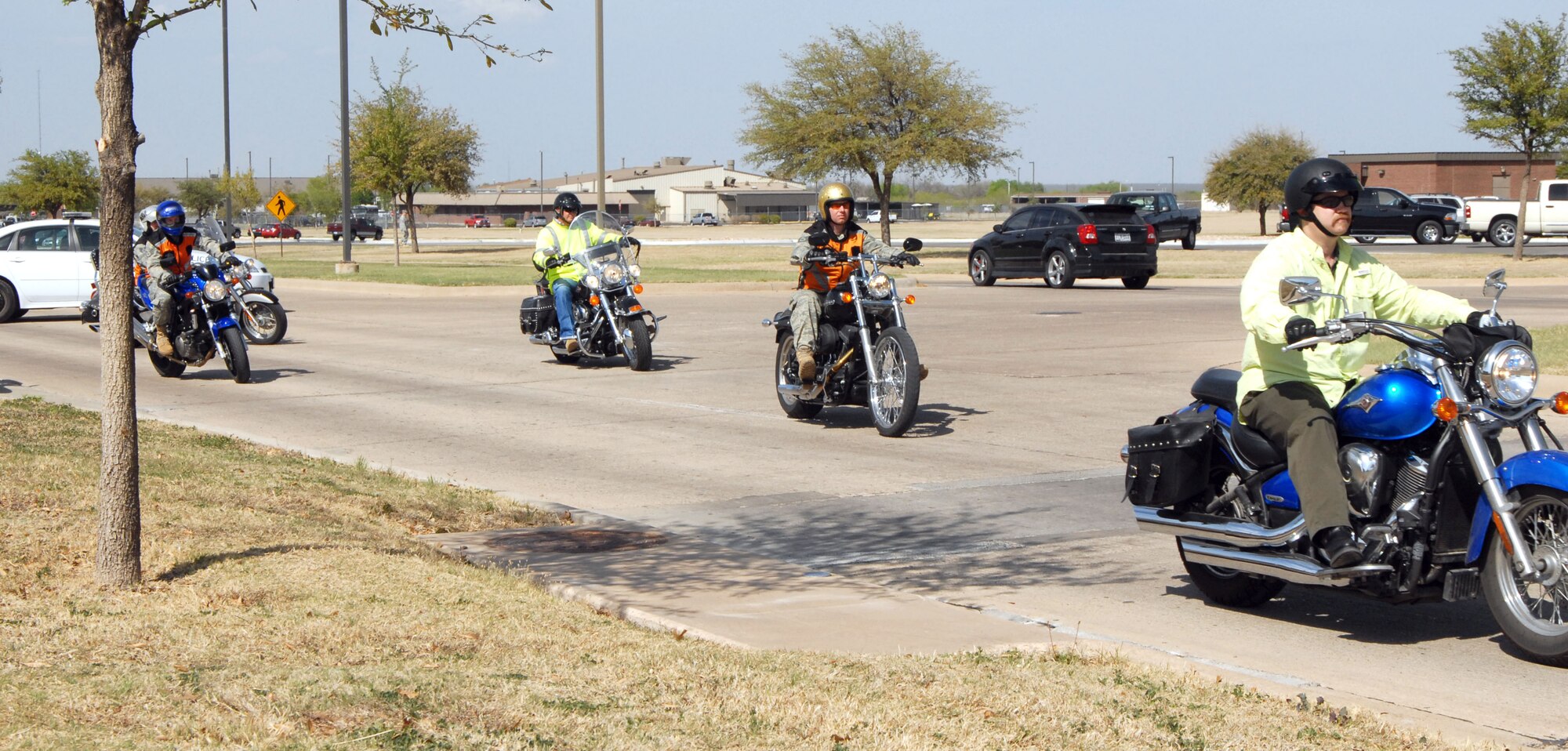 GOODFELLOW AIR FORCE BASE, Texas-- Members of the Green Knights Motorcycle Safety Club parade around base with a police escort, March 25. More than 20 motorcyclists participated in the event, which is held to raise motorcycle safety awareness. (U.S. Air Force photo/Airman 1st Class Jessica Keith)