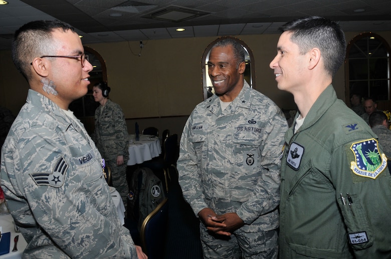 ROYAL AIR FORCE LAKENHEATH, England - Senior Airman Edgar Veguilla (left), 48th Security Forces Squadron Base Defense Operations Center controller, talks to Brig. Gen. Jimmy E. McMillian (middle), Air Force Security Forces director, and Col. John Quintas (right), 48th Fighter Wing commander,  after being awarded the Purple Heart on March 28, 2011. Airman Veguilla was the last of four Airmen to be awarded the medal for wounds received in action during the shooting incident at Frankfurt International Airport on March 2, 2011. (U.S. Air Force photo/Senior Airman Eboni Reams)