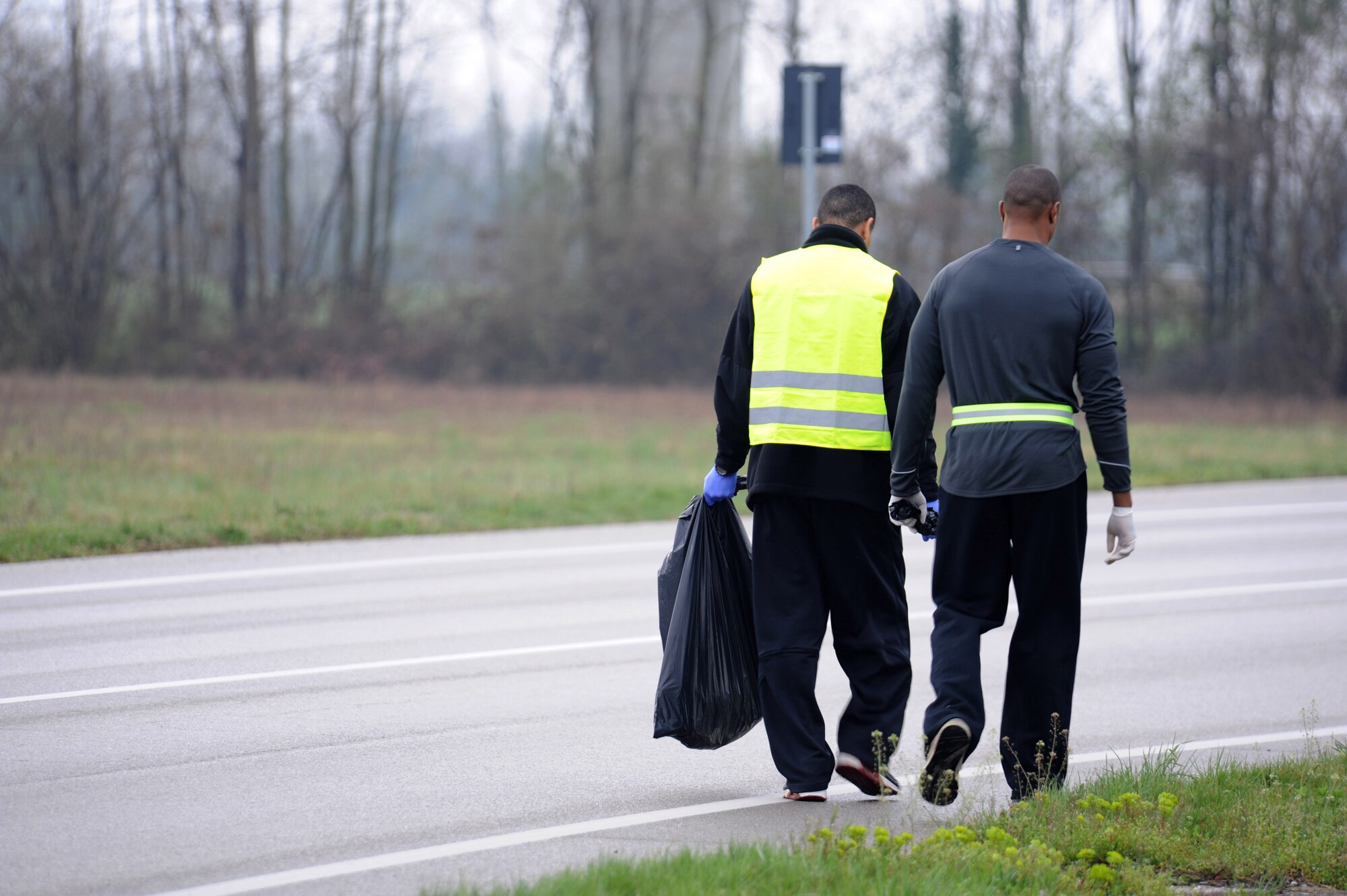 Members of the 8th Air Support Operations Squadron collect trash along the side of the road as part of the 8th ASOS community beautification project, March 27.  Eighteen volunteers cleaned roads from Area F to Area 1, and those leading from Area F to the mountain highway, collecting 25 bags of refuse.  (U.S. Air Force photo/ Staff Sgt. Nadine Y. Barclay)