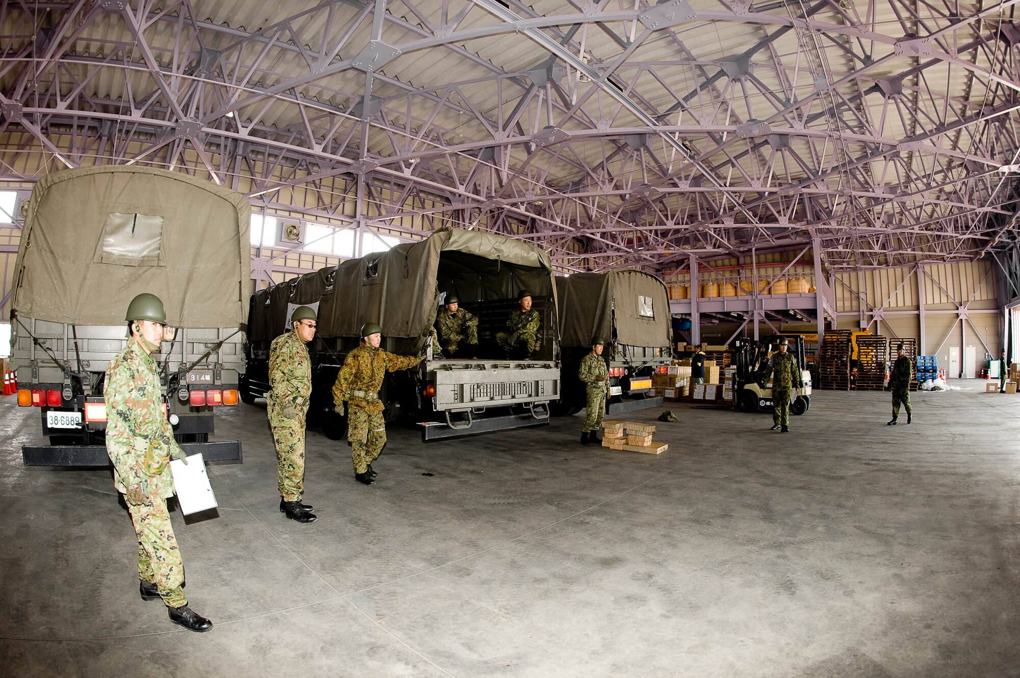HANAMAKI AIRPORT, Japan -- Members of the Japanese Defense Force wait for a forklift load of supplies, transported by a 36th Airlift Squadron C-130, to be delivered at Hanamaki Airport, March 29. The C-130 will deliver humanitarian goods and supplies to the Japanese Defense Force in support of Operation Tomodachi. (U.S. Air Force photo by/Master Sgt. Jeromy K. Cross)






