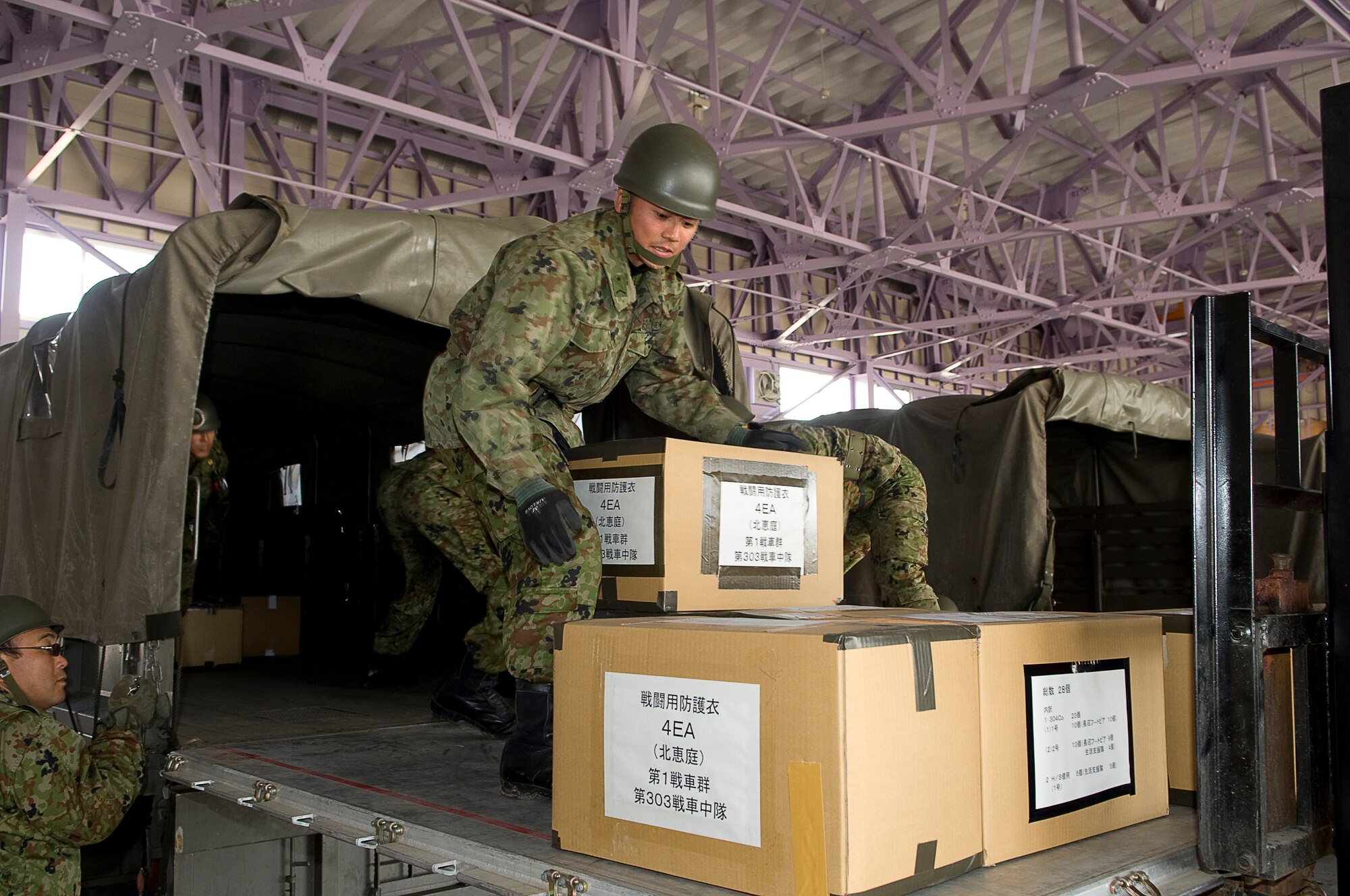 HANAMAKI AIRPORT, Japan -- A member of the Japanese Defense Force loads a truck with boxes delivered by a 36th Airlift Squadron C-130 at Hanamaki Airport, March 29. The C-130 will deliver humanitarian goods and supplies to the Japanese Defense Force in support of Operation Tomodachi. (U.S. Air Force photo by/Master Sgt. Jeromy K. Cross)




