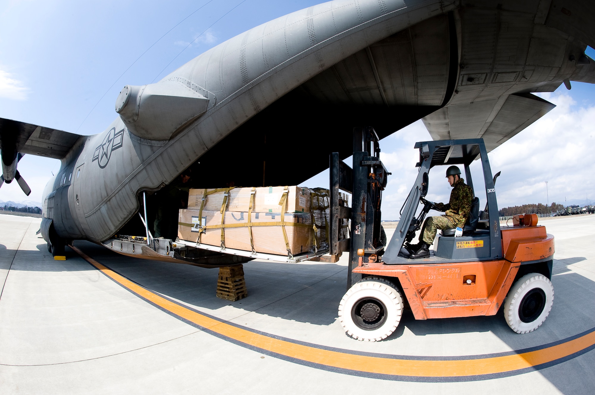 HANAMAKI AIRPORT, Japan -- A member of the Japanese Defense Force uses a forklift to unload a 36th Airlift Squadron C-130 at Hanamaki Airport, March 29. The C-130 will deliver humanitarian goods and supplies to the Japanese Defense Force in support of Operation Tomodachi. (U.S. Air Force photo by/Master Sgt. Jeromy K. Cross)





