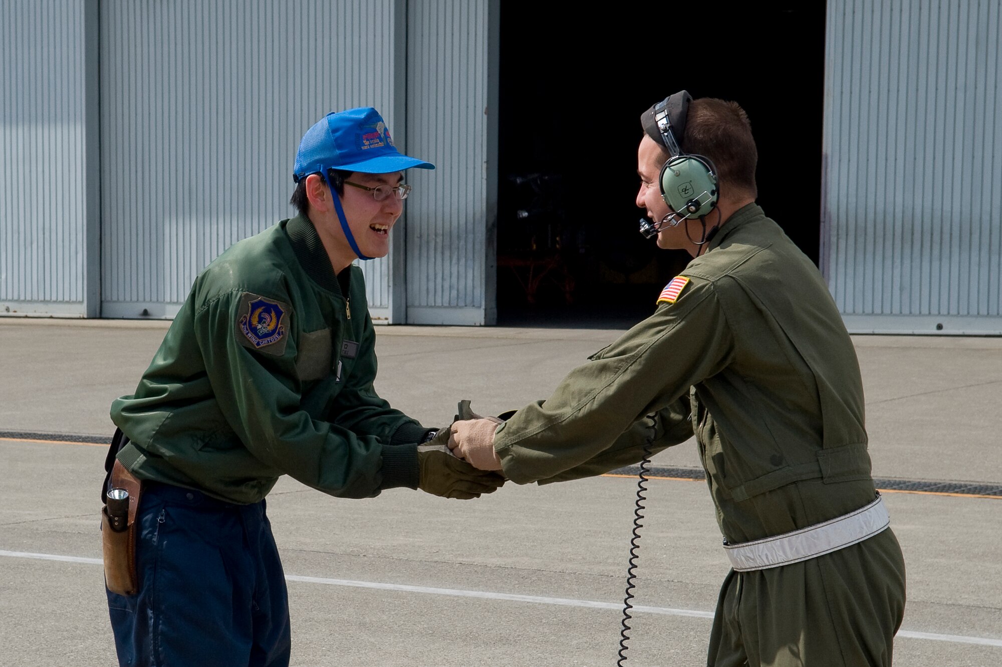 CHITOSE AIR BASE, Japan -- U.S. Air Force Staff Sgt. Nick Alarcon, 36th Airlift Squadron, and a member of the Japanese Defense Force, exchange patches at Chitose Air Base, March 29. Because of Yokota's long-standing working relationship with Japanese forces, Airmen are able to rapidly respond with critically needed supplies and capabilities in times of crisis. (U.S. Air Force photo by/Master Sgt. Jeromy K. Cross)





