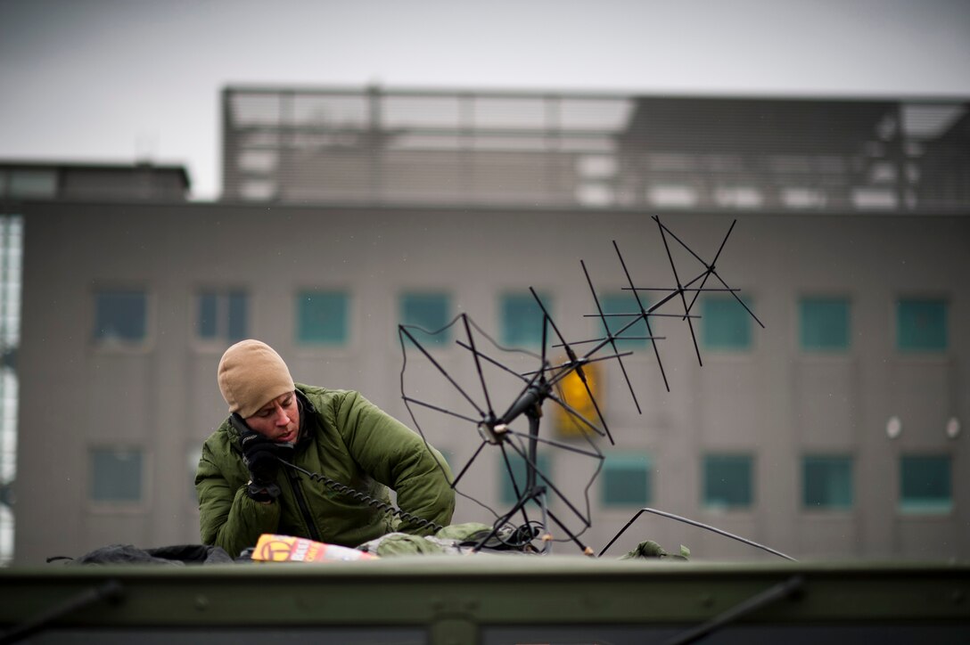 A member of the 320th Special Tactics Squadron sets up a satellite link for communications at Sendai Airport March 16. (U.S. Air Force photo/Staff Sgt. Samuel Morse)