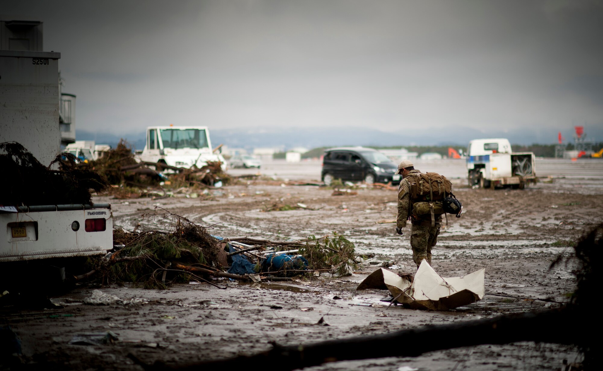 A pararescueman with the 320th Special Tactics Squadron searches the rubble at Sendai Airport, looking for survivors March 16. (U.S. Air Force photo/Staff Sgt. Samuel Morse)