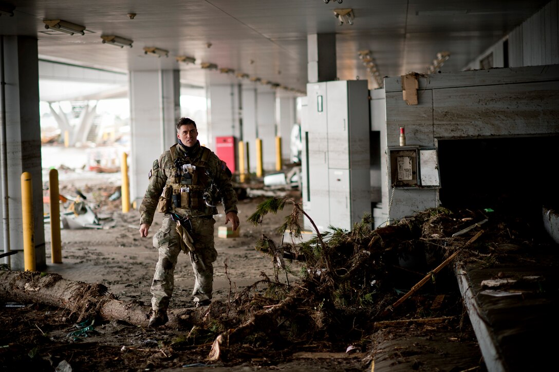 A pararescueman with the 320th Special Tactics Squadron looks through rubble to find survivors at Sendai Airport March 16. The dirt along the ground-level exterior walls shows just how high the water level rose during the March 11 tsunami. (U.S. Air Force photo/Staff Sgt. Samuel Morse)