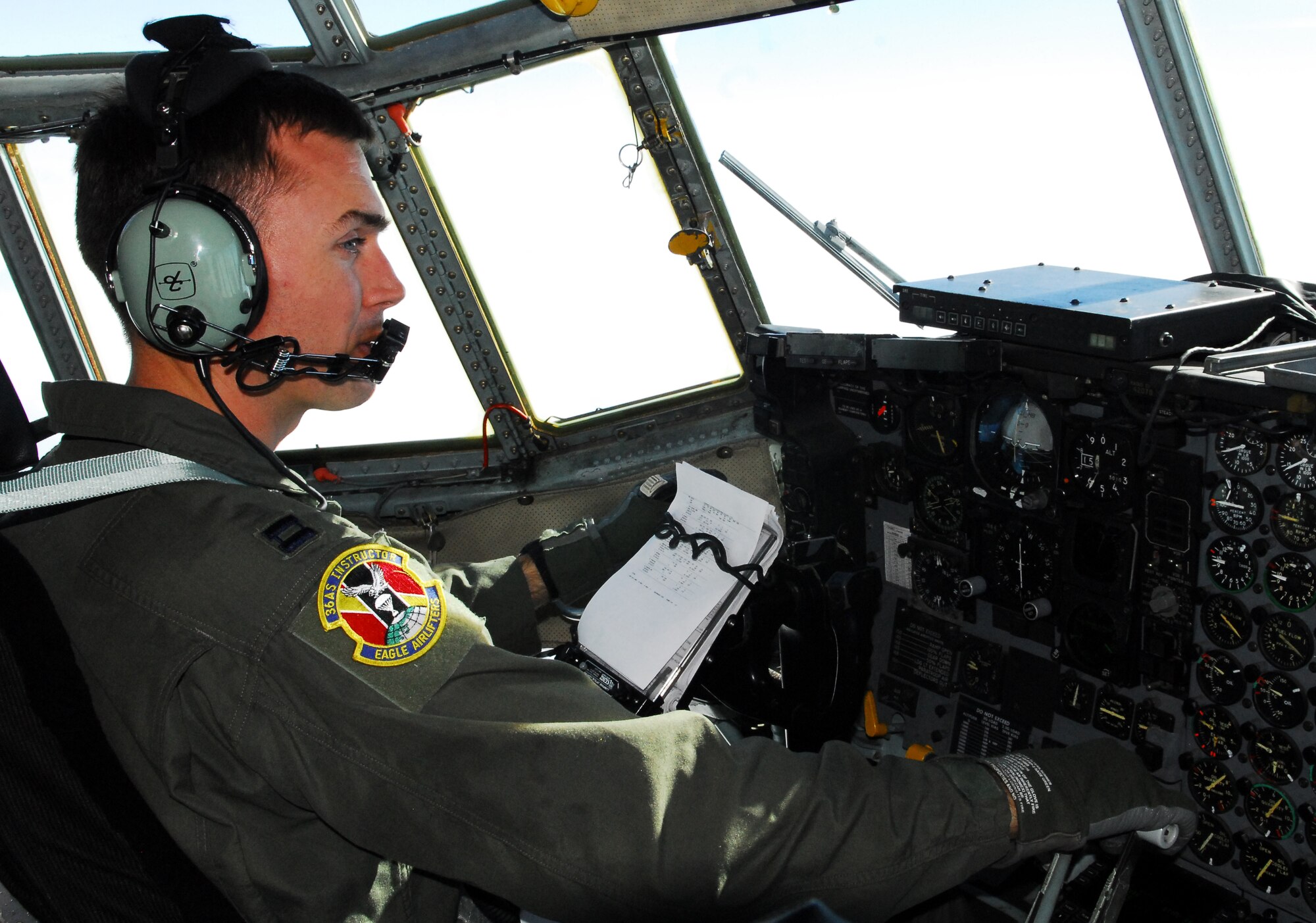 YOKOTA AIR BASE, Japan -- Capt. William Dunn, a C-130 pilot assigned to the 36th Airlift Squadron, checks his flight plan during a mission from Matsushima Air Base, Japan, to Yokota, March 29. Captain Dunn, a native of Woodside, Calif., was part of a team from Yokota that delivered more than 11,000 pounds of relief supplies to support the Government of Japan's request for humanitarian assistance. (U.S. Air Force photo/Staff Sgt. Robin Stanchak)