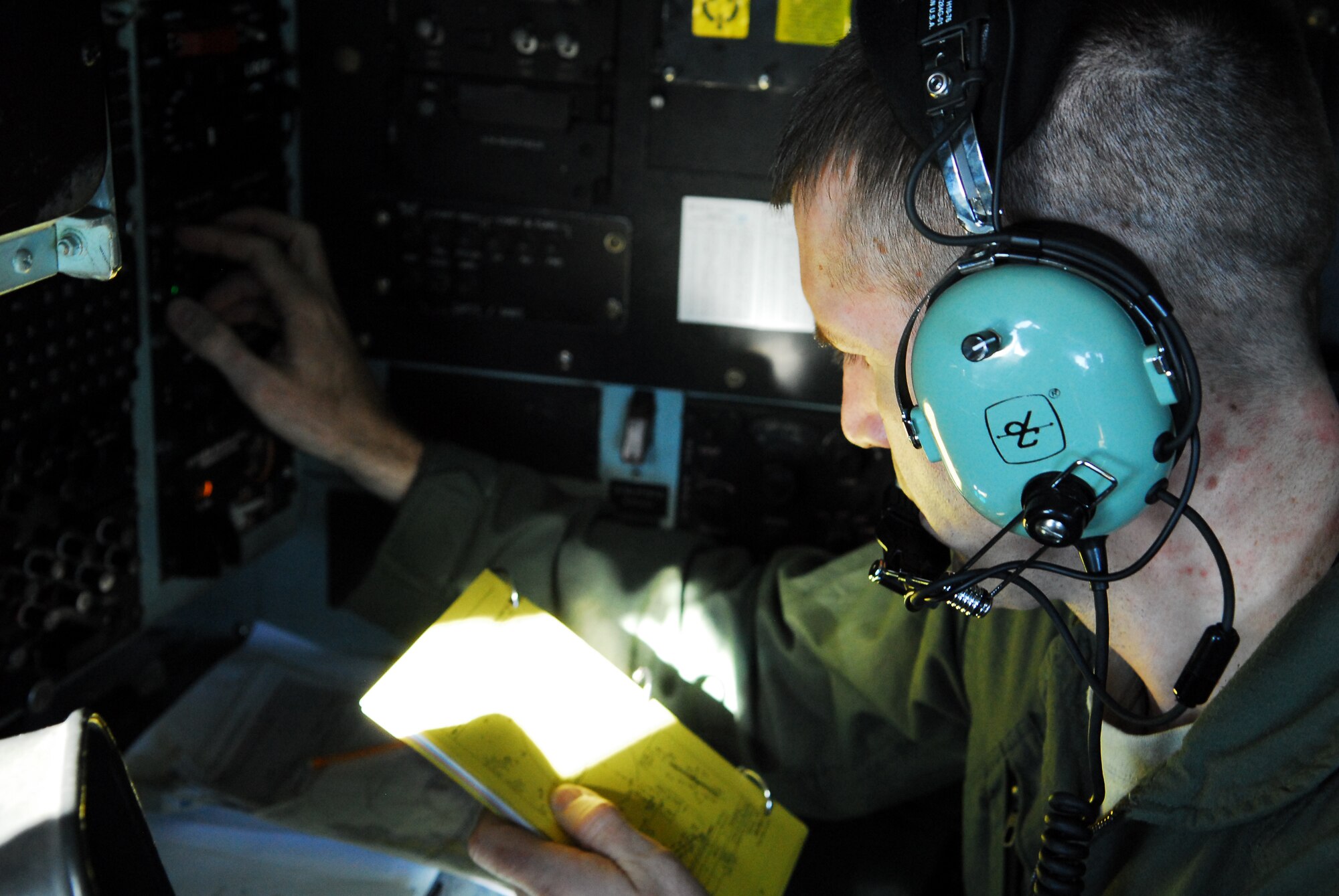 YOKOTA AIR BASE, Japan -- 1st Lt. Jon Parks, a C-130 navigator from the 36th Airlift Squadron, reviews a flight manual during a mission to Matsushima Air Base, Japan, March 29. Lieutenant Parks, a native of Sacramento, Calif., was part of a team from Yokota that delivered more than 11,000 pounds of relief supplies to support the Government of Japan's request for humanitarian assistance. (U.S. Air Force photo/Staff Sgt. Robin Stanchak)