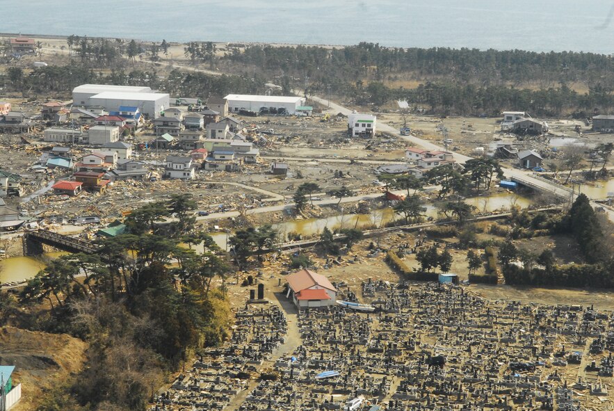 MATSUSHIMA, Japan --  Silence shrouds an aircrew as their C-130 passes over a cemetery in Matsushima, Japan.  Nearly two weeks have passed since the area was hit by an unforgiving earthquake and tsunami. During the flight, members from the 36th Airlift Squadron, Yokota Air Base, delivered more than 11,000 pounds of relief supplies to support the Government of Japan's request for humanitarian assistance. (U.S. Air Force photo/Staff Sgt. Robin Stanchak)