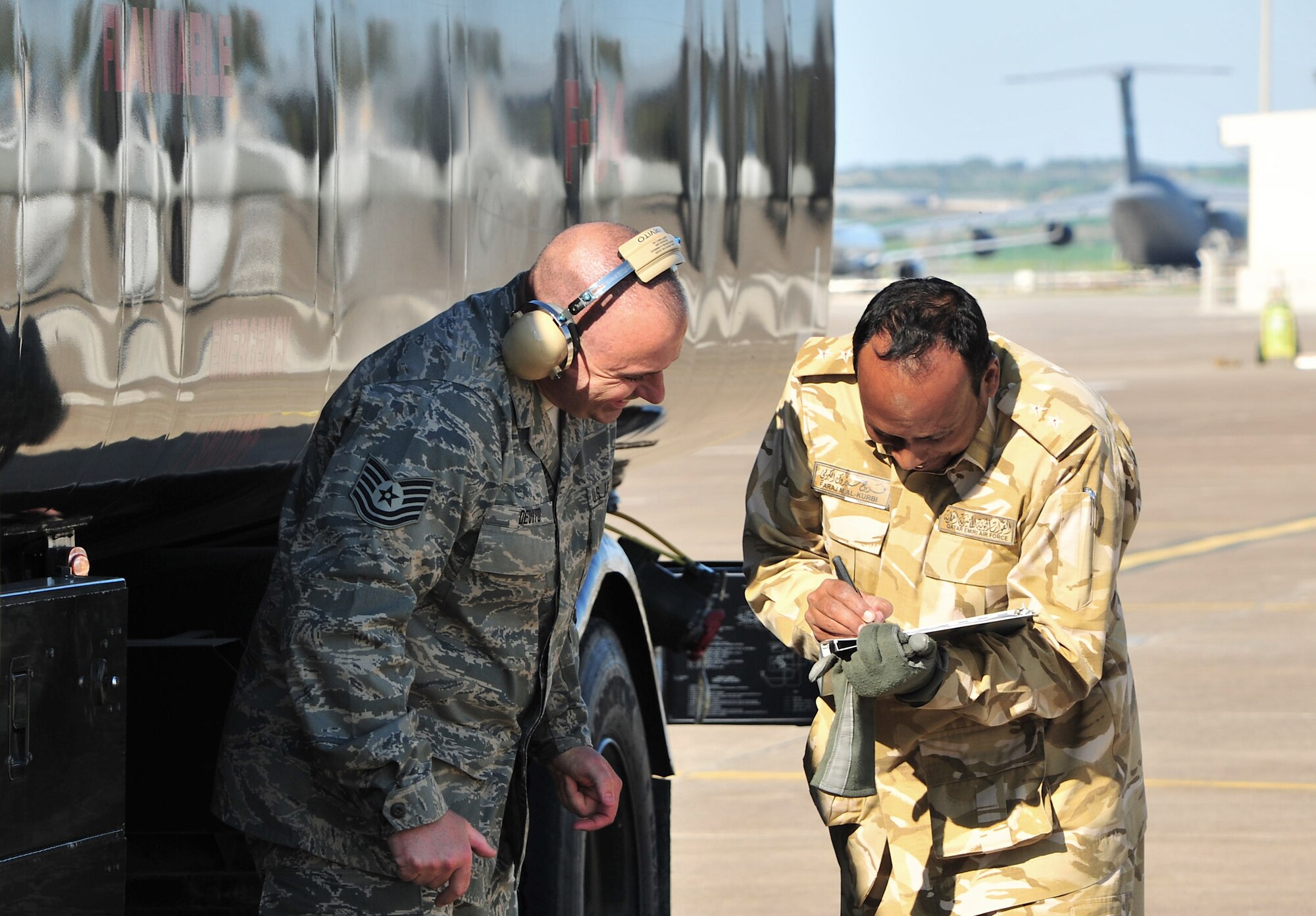 Tech. Sgt. Andrew Devito, of the 39th Logistics Readiness Squadron, and a Qatari airman work together to complete a refueling mission in support of Operation Odyssey Dawn March 25, 2011, at Incirlik Air Base, Turkey.  Joint Task Force Odyssey Dawn is the U.S. Africa Command task force established to provide operational and tactical command and control of U.S. military forces supporting the international response to the unrest in Libya and enforcement of United Nations Security Council Resolution 1973. UNSCR 1973 authorized all necessary measures to protect civilians in Libya under threat of attack by Qadhafi regime forces. JTF Odyssey Dawn is commanded by U.S. Navy Admiral Samuel J. Locklear, III. (U.S. Air Force photo by Staff Sgt. Alexandre Montes)

