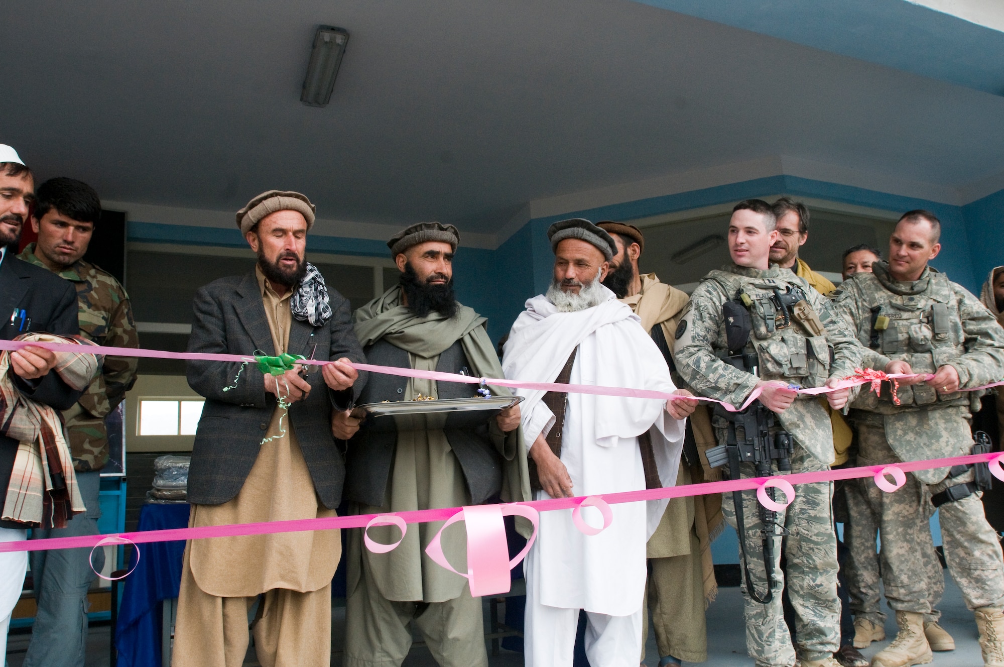 KAPISA PROVINCE, Afghanistan – U.S. Air Force Lt. Col. Michael Sierco, Kapisa Provincial Reconstruction Team commander (far right) from Bowie, Md., and U.S. Air Force Capt. Seth Platt, Kapisa PRT lead Engineer (left) from Pomfert Conn., participate in a ribbon cutting ceremony with school and Government of Islamic Republic of Afghanistan officials at Kohi Girl’s School in Afghanya here, March, 28. The girl’s school was built to accommodate more than 400 female students from the Afghanya valley. The mission of Kapisa PRT is to help facilitate the local and national governments of Afghanistan working together to help provide for the development and security needs of the Afghan people.  (Photo by U.S. Air Force Staff Sgt. Kyle Brasier, Kapisa Provincial Reconstruction Team Public Affairs / released)