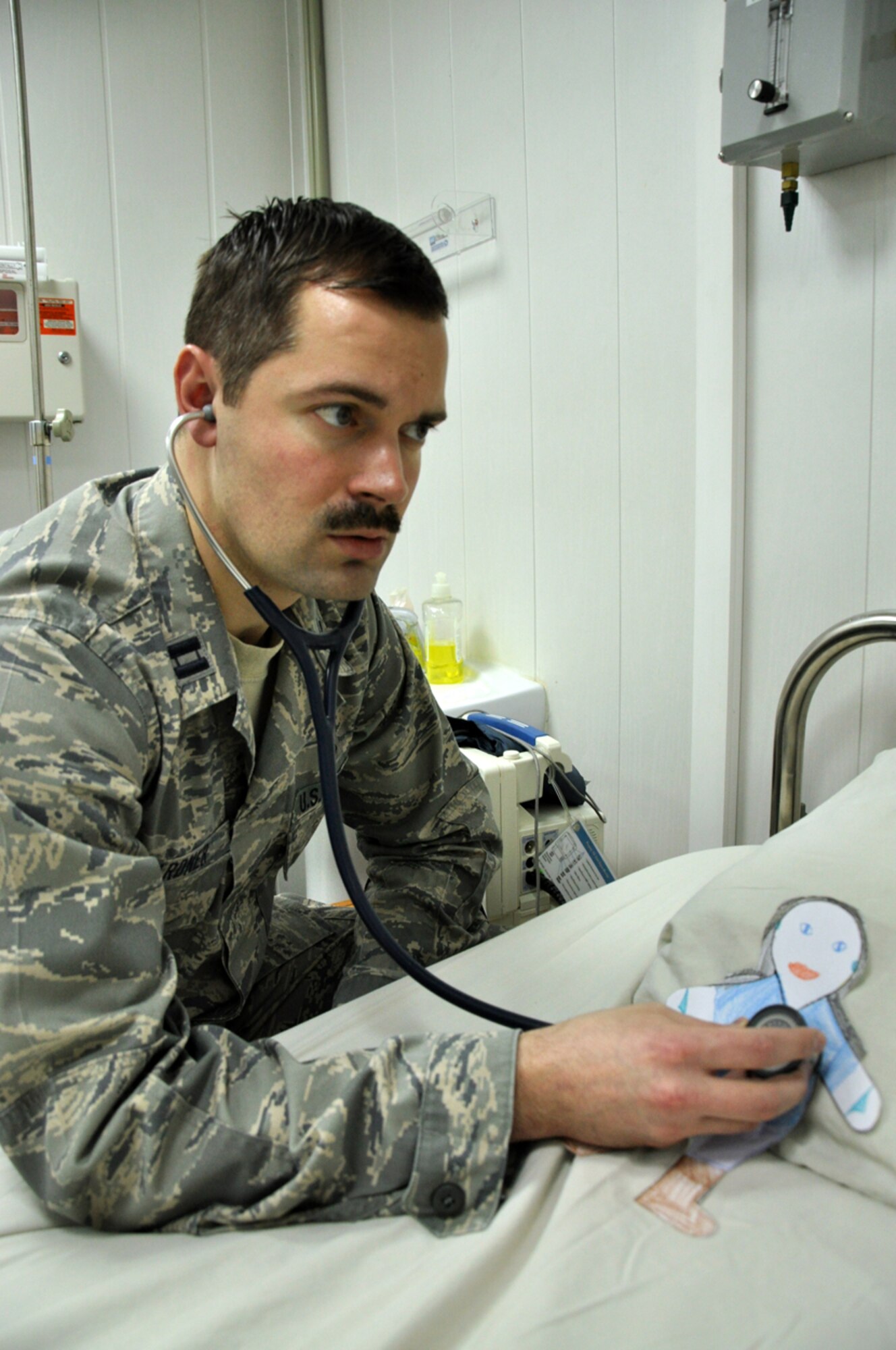Flat Stanley is examined by Doctor (Capt.) Michael Gardner, 376th Expeditionary Medical Group, Transit Center at Manas, Kyrgyzstan. Upon arriving at the Transit Center, Flat Stanley has been spotted participating in a number of Transit Center activities. Stanley is now safely back in his envelope and in the mail on his way home to North Carolina. (U.S. Air Force photo/Master Sgt. Daniel Nathaniel III)