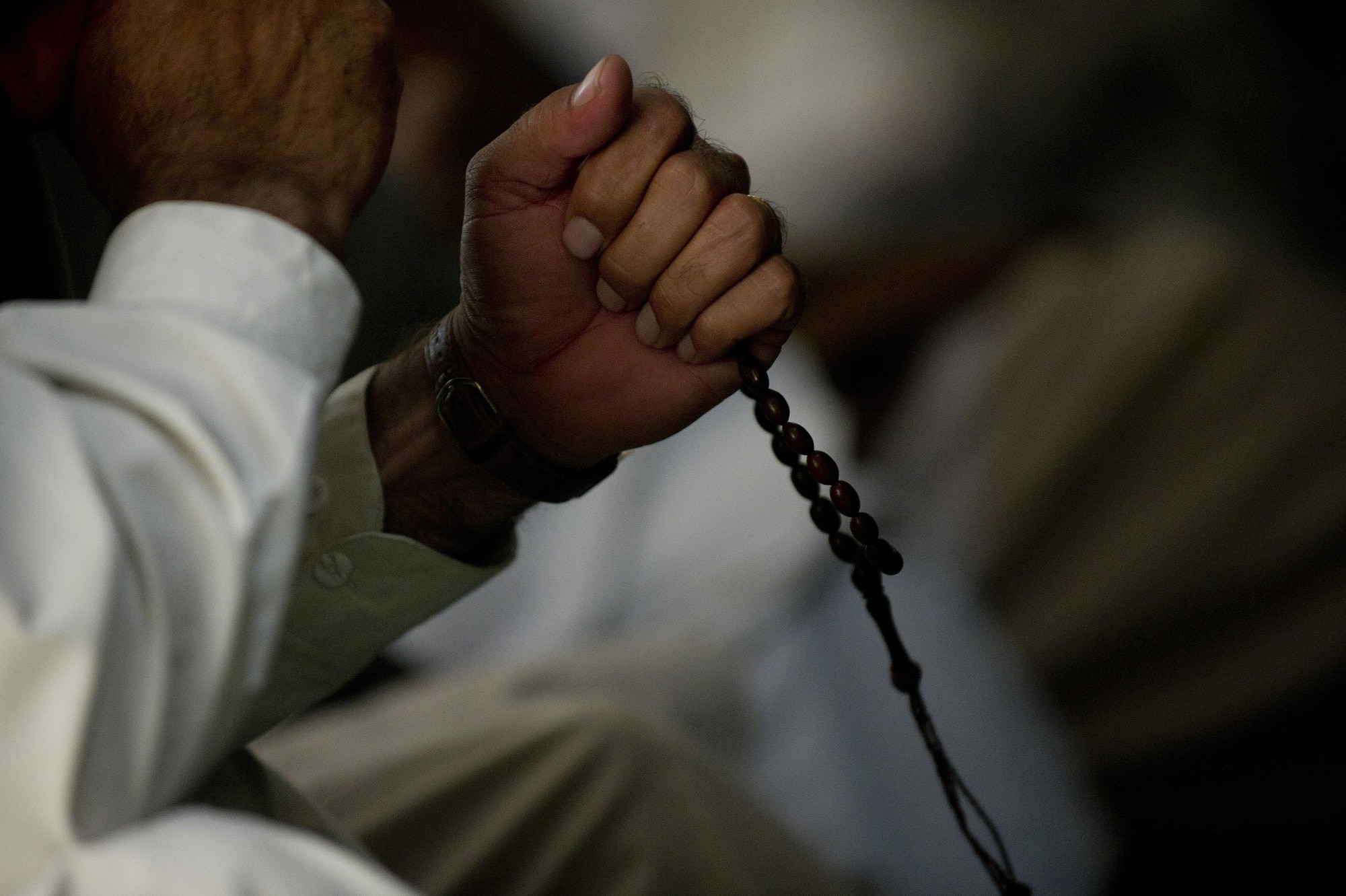 An Afghan mullah holds on to his prayer beads as he listens to other Mullah's speak during a Mullah Shura in Qalat City, Afghanistan. The Mullah Shura was a meeting of religious leaders in the Zabul province used to discuss how they can use religion to help resolve violence and fighting in Afghanistan. (U.S. Air Force photo by Master Sgt. Adrian Cadiz)
