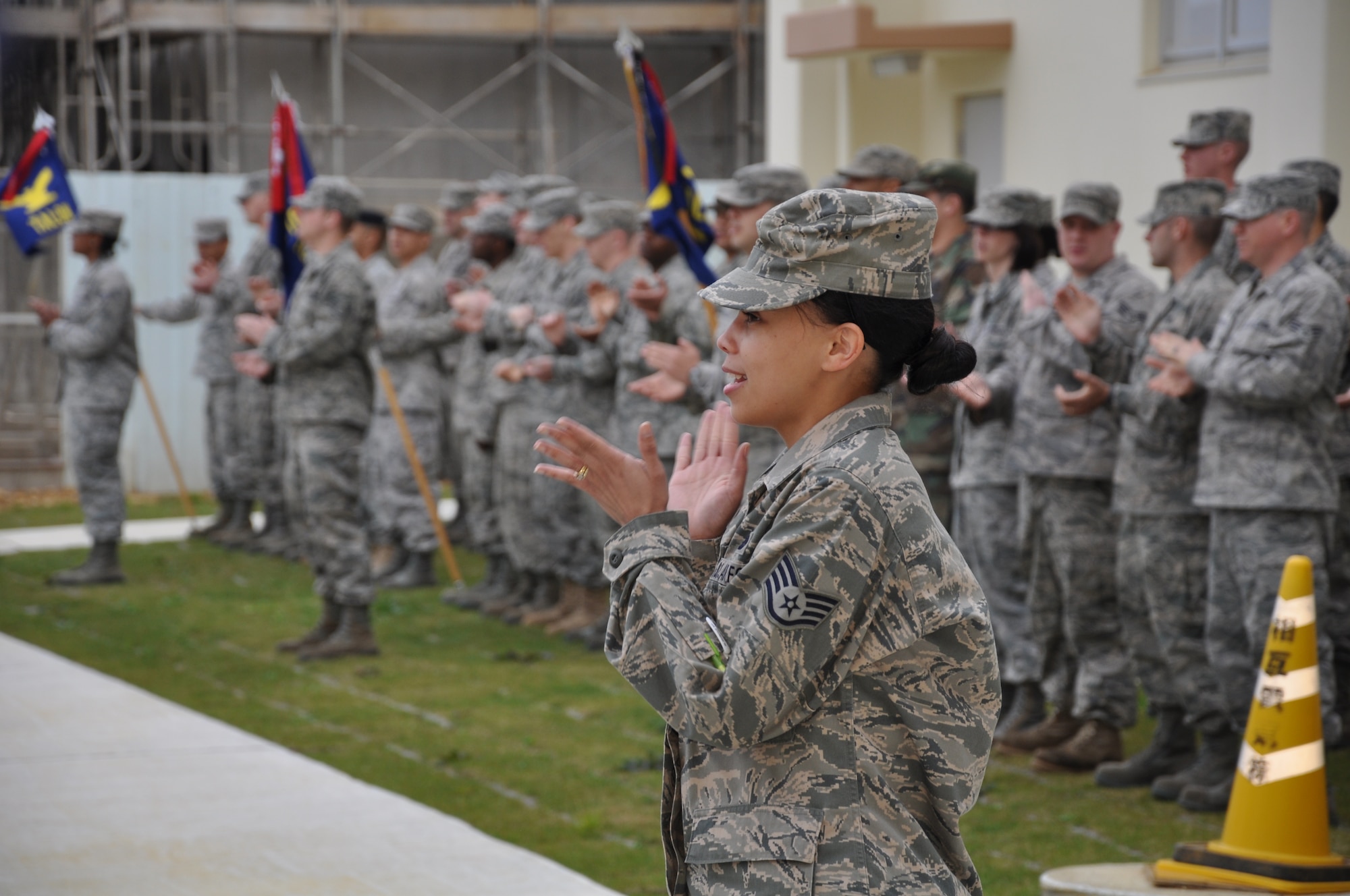 Staff Sgt. Brandy Crespo, Airman Leadership School student and class 1st Sgt leads her flight in singing the Air Force song after retreat, here Mar.16. Sgt. Crespo’s class is the first ALS class in the new Erwin Professional Military Education Center that opened earlier this month. (U.S. Air Force photo by Master Sgt. Geoff Robertson)