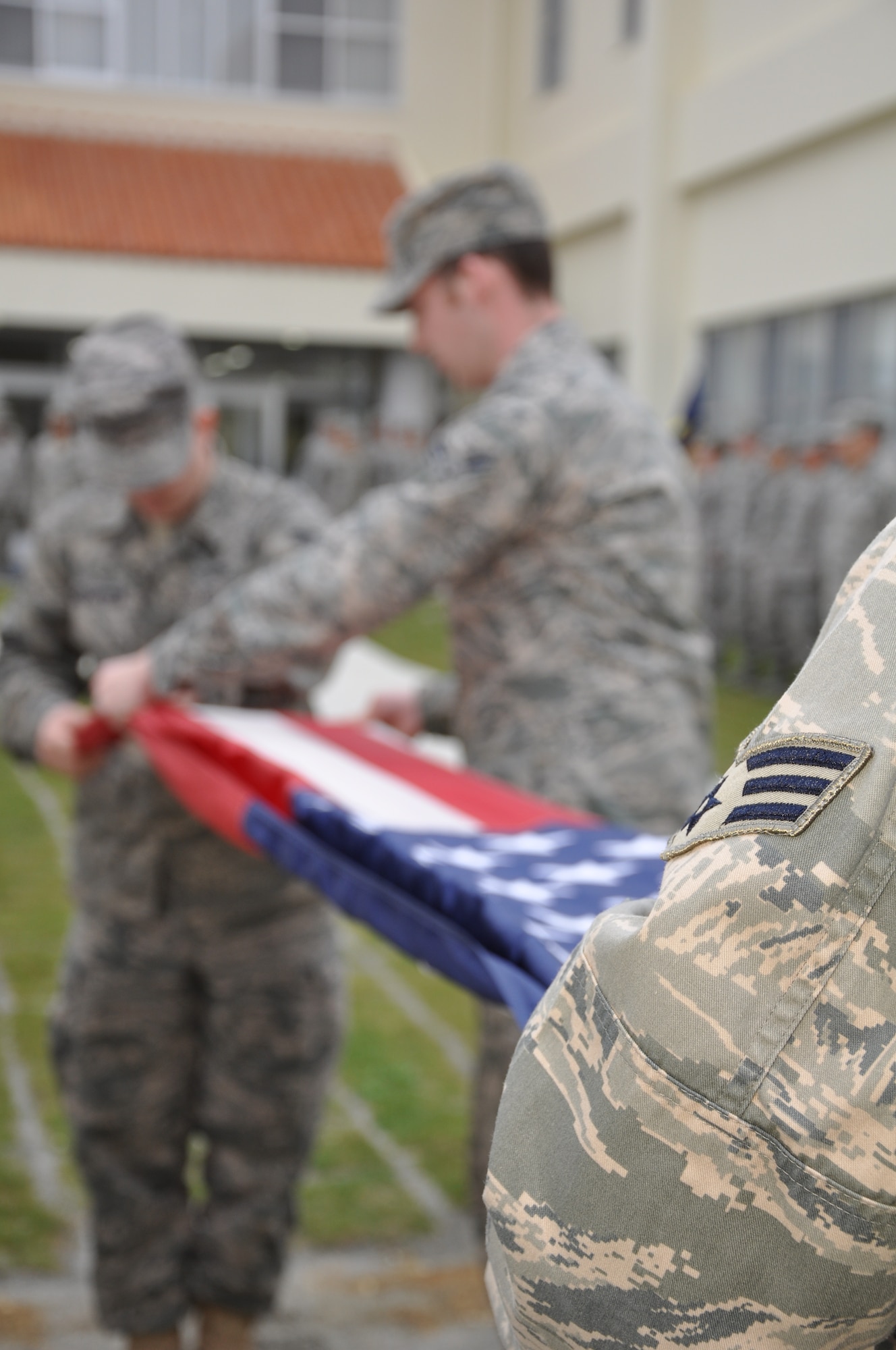Senior Airmen attending Airman Leadership School at Erwin Professional Military Education Center learn customs and courtesies folding the American flag during retreat, here Mar. 13. Senior airmen spend six weeks learning the skills needed to supervise and lead Airmen.  (U.S. Air Force photo by Master Sgt. Geoff Robertson) 