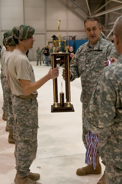 Maj. Gen. Stephen Danner, Missouri National Guard adjutant general, hands the first place trophy to Matthew Martinez of Waynesville High School, Mo. Schools from across the Midwest competed in the Junior ROTC 5th annual Raider Challenge hosted by the Missouri Air National Guard at the 139th Airlift Wing, St. Joseph, Mo., March 26, 2011. (U.S. Air Force photo by Airman 1st Class Kelsey Stuart/Released)