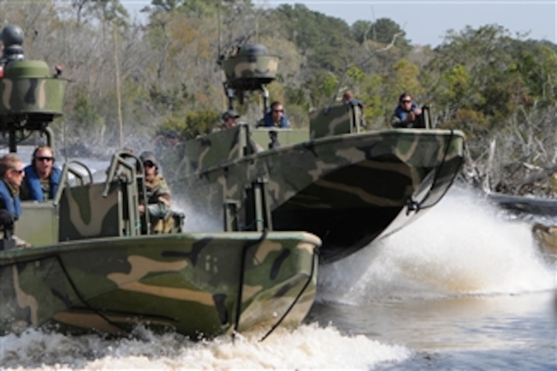Sailors assigned to Riverine Squadron 3 and marines from the Royal Netherlands marine corps perform a right echelon maneuver in riverine assault boats during a three-week cross-training exercise to exchange tactics and refine skills at Camp Lejeune, N.C., on March 22, 2011.  