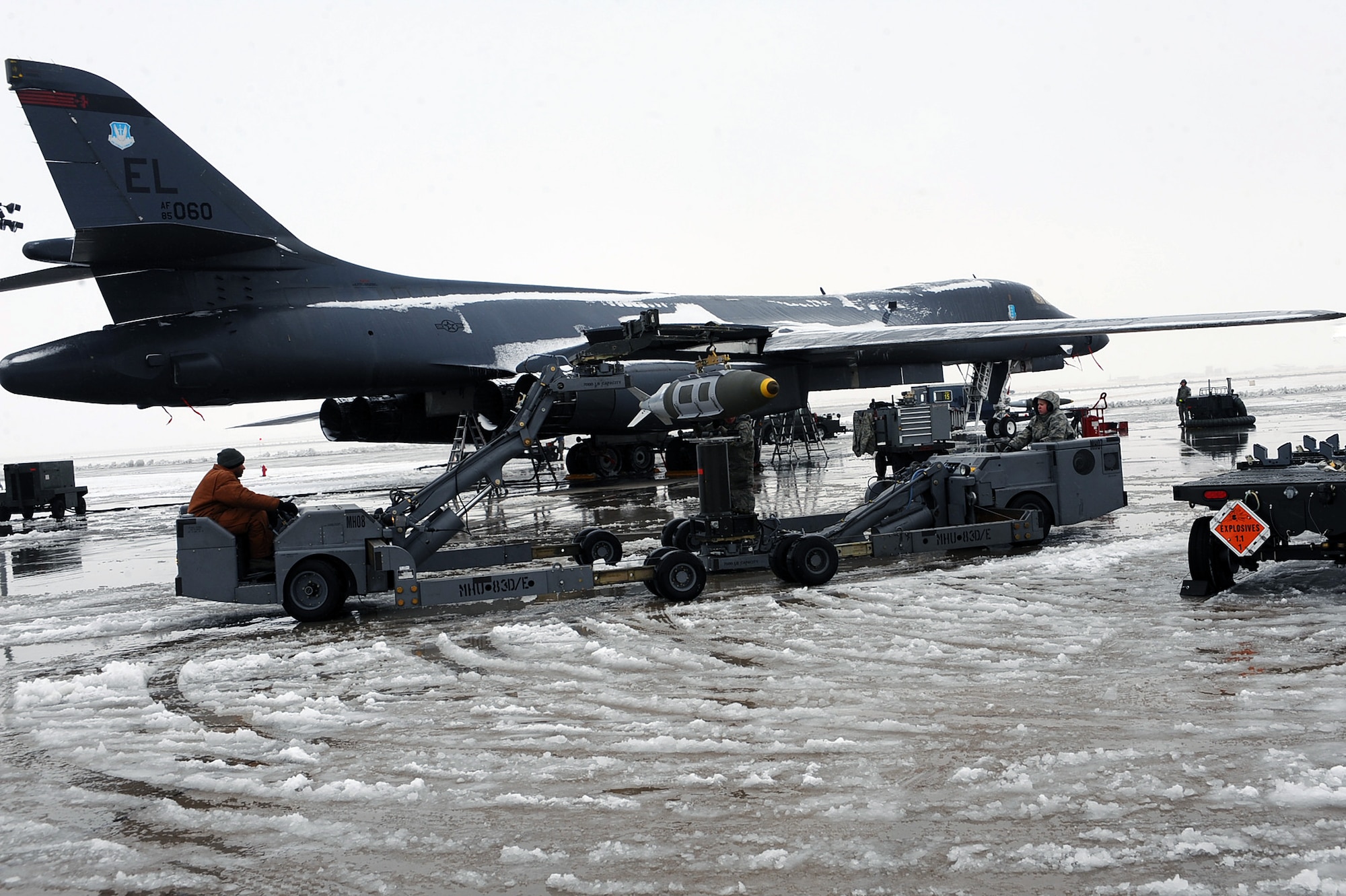 Airmen from the 28th Aircraft Maintenance Squadron transfer a two thousand pound bomb from a weapons trailer to the load jammer in preparation of Operation Odyssey Dawn at Ellsworth Air Force Base, S.D., March 26, 2011. Once secure on the load jammer, the two thousand pound bomb will then be loaded into the aircraft bomb bay. (U.S. Air Force photo/Senior Airman Kasey Close)