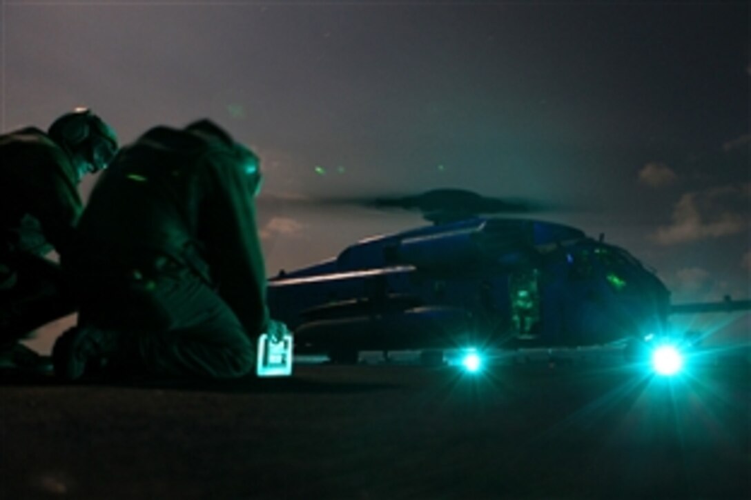 U.S. Marines conduct electronic checks on a  CH-53E Super Stallion Helicopters before taking off to rescue a downed Air Force F-15E Strike Eagle pilot and weapons officer in the Mediterranean Sea, March 21, 2011. The aviators experienced mechanical problems while supporting Joint Task Force Odyssey Dawn. 