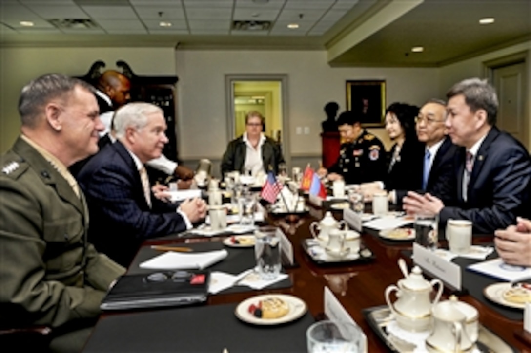 U.S. Defense Secretary Robert M. Gates, left center, meets with Mongolian Defense Minister Luvsanvandan Bold, right, for bilateral security talks at the Pentagon, March 29, 2011. Marine Corps Gen. James E. Cartwright, left, vice chairman of the Joint Chiefs of Staff, joined Gates for the meeting.