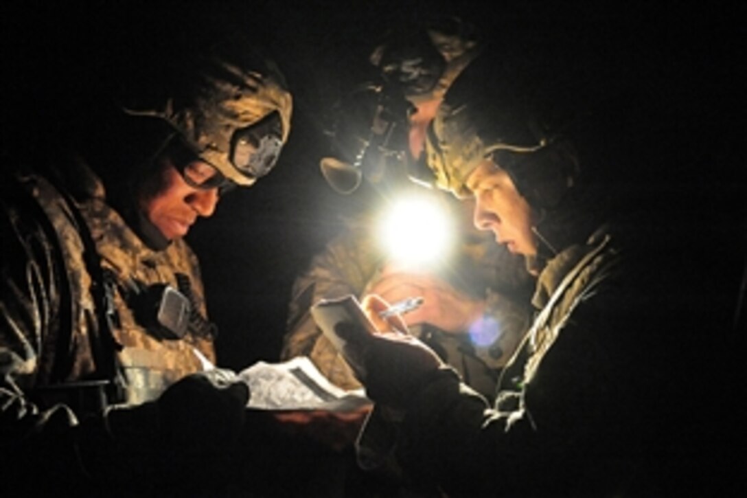 U.S. Air Force airmen write down a description of weapons found in a cache during Desert Eagle at the Nevada Test and Training Range, March 16, 2011. The airmen are assigned to the 822nd Base Defense Squadron.