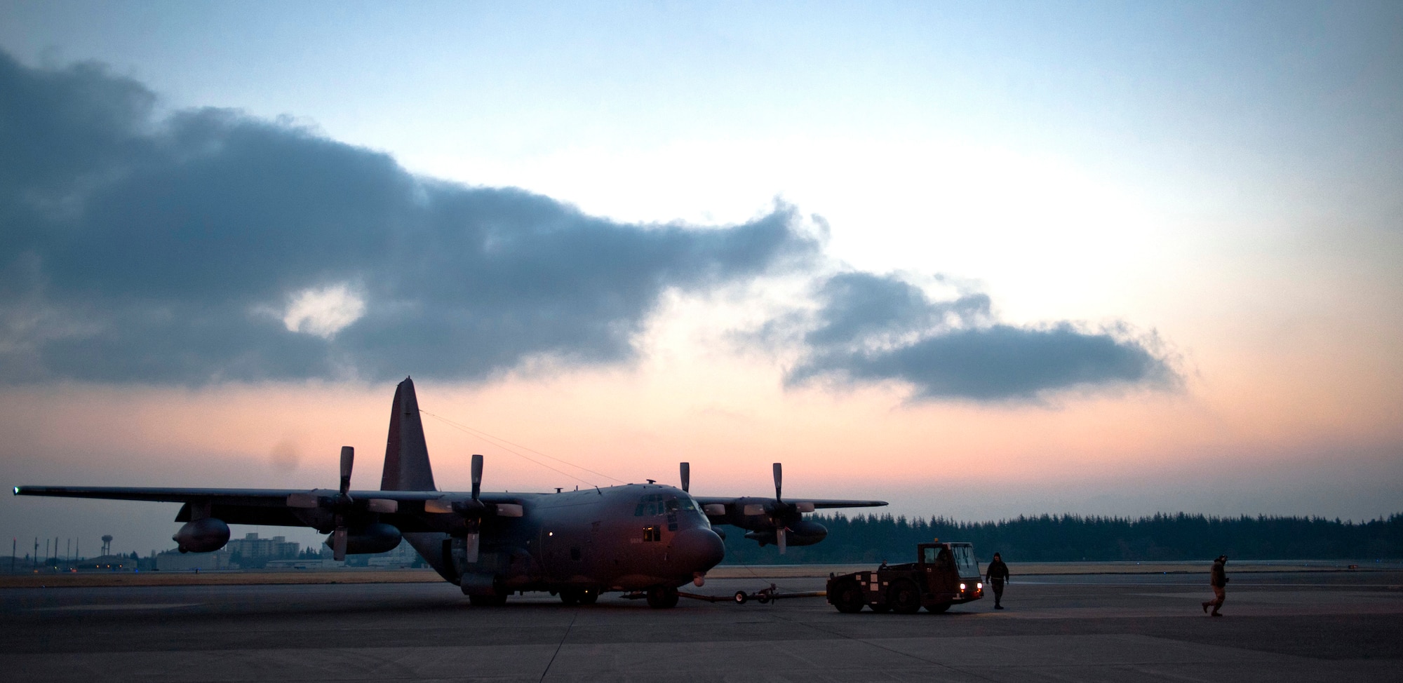 YOKOTA AIR BASE, Japan -- An MC-130P Combat Shadow is towed down the flight line while undergoing routine maintenance here March 31. As part of Operation Tomodachi, the U.S. military has humanitarian assistance capabilities positioned in the affected region that are supporting emergency relief efforts and trying to minimize human suffering. U.S. military assets include a wide range of equipment and air, sea and ground capabilities and expertise. (U.S. Air Force photo/Staff Sgt. Chad C. Strohmeyer)