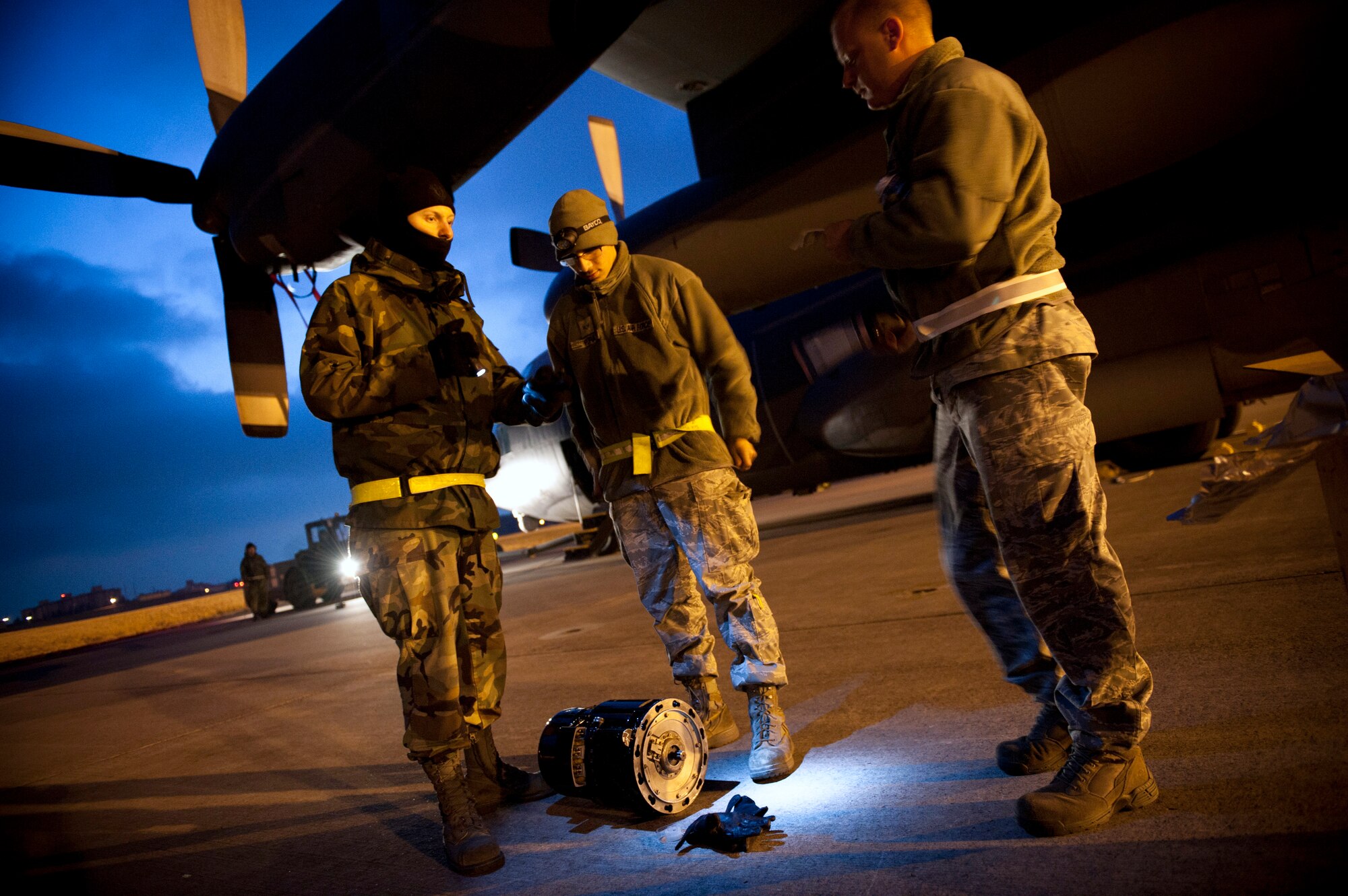 YOKOTA AIR BASE, Japan -- Staff Sgt. Daniel Wolfbauer, Senior Airman John Pura and Tech Sgt. Dennis Henderson, 353rd Special Operations Maintenance Squadron, discuss maintenance procedures for an MC-130P Combat Shadow here March 31. As part of Operation Tomodachi, the U.S. military has humanitarian assistance capabilities positioned in the affected region that are supporting emergency relief efforts and trying to minimize human suffering. U.S. military assets include a wide range of equipment and air, sea and ground capabilities and expertise. (U.S. Air Force photo/Staff Sgt. Chad C. Strohmeyer)