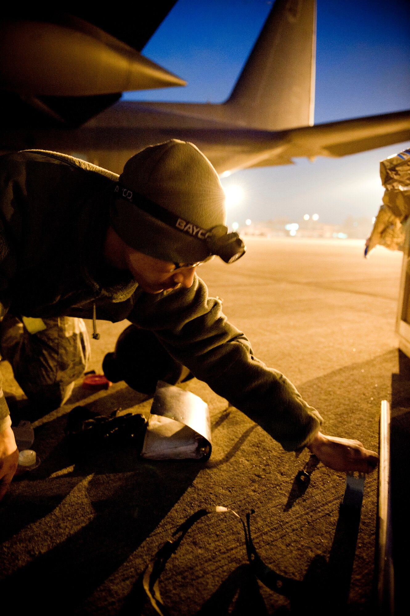 YOKOTA AIR BASE, Japan -- Senior Airman John Pura, 353rd Special Operations Maintenance Squadron, works all through the night performing maintenance on an MC-130P Combat Shadow here March 31. As part of Operation Tomodachi, the U.S. military has humanitarian assistance capabilities positioned in the affected region that are supporting emergency relief efforts and trying to minimize human suffering. U.S. military assets include a wide range of equipment and air, sea and ground capabilities and expertise. (U.S. Air Force photo/Staff Sgt. Chad C. Strohmeyer)