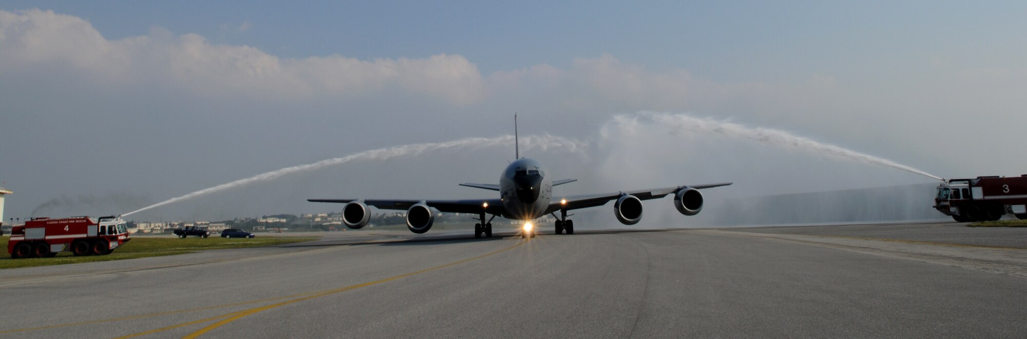 Col. Ricky Rupp, 18th Wing vice commander, pilots a KC-135 Stratotanker aircraft through a water arch during his fini-flight at Kadena Air Base, Japan, March 30. Col. Rupp will assume command of the 22nd Air Refueling Wing, McConnell Air Force Base in June. (U.S. Air Force photo/Airman 1st Class Jarvie Z. Wallace)