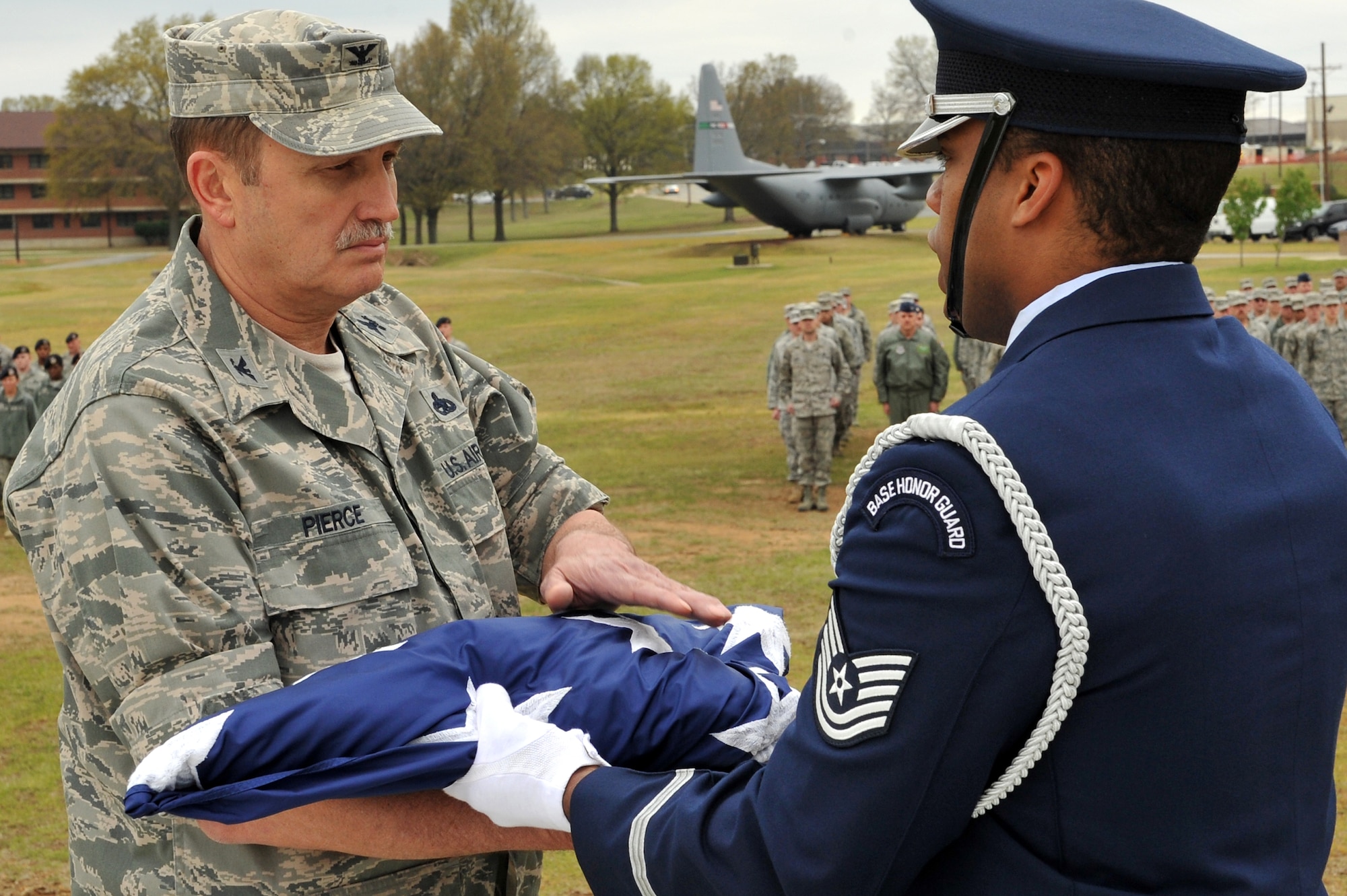 Col. George Pierce, 19th Maintenance Group commander, receives a U.S. Flag from an Honor Guard member after a retreat ceremony marking Welcome Home Vietnam Veterans Day March 30, 2011, at Little Rock Air Force Base, Ark.  Colonel Pierce is believed to be the last serving active-duty Vietnam War-era Airman serving on the installation. Welcome Home Vietnam Veterans Day, designated by U.S. Senate Resolution 55, marks the day the last American troops pulled out of Vietnam. More than 58,000 U.S. Troops were killed in Vietnam and more than 300,000 were wounded. (U.S. Air Force photo/Staff Sgt. Chris Willis)