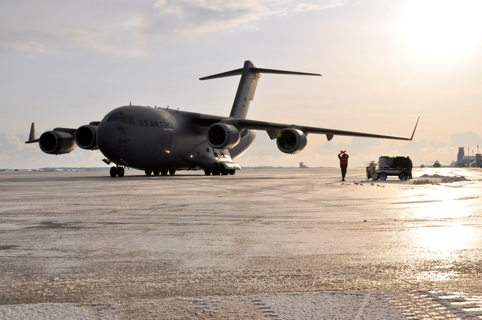 MISAWA AIR BASE, Japan – Senior Airman Justin Ackerman, 35th Maintenance Squadron transient alert technician, guides a C-17 Globemaster from Joint Base Elmendorf-Richardson, Alaska, on the flightline March 27, 2011.  Airman Ackerman, a native of Columbia, S.C., said he was proud to assist in Operation Tomodachi in the aftermath of the earthquake and tsunami that devastated Japan March 11, 2011.  (U.S. Air Force photo by Senior Airman Joe W. McFadden / RELEASED) 