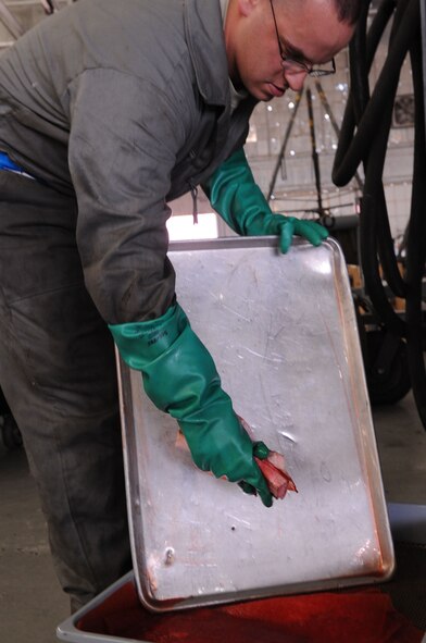 Staff Sgt. Phillip Hovey, 2nd Maintenance Squadron Aerospace Ground Equipment Flight technician, cleans up hydraulic fluid before conducting maintenance on a hydraulic test stand March 30 at Barksdale Air Force Base, La. The test stand is frequently used to operate the hydraulic systems on the B-52H Stratofortress.   (U.S. Air Force Photo/Staff Sgt. Terri Barriere)(RELEASED)