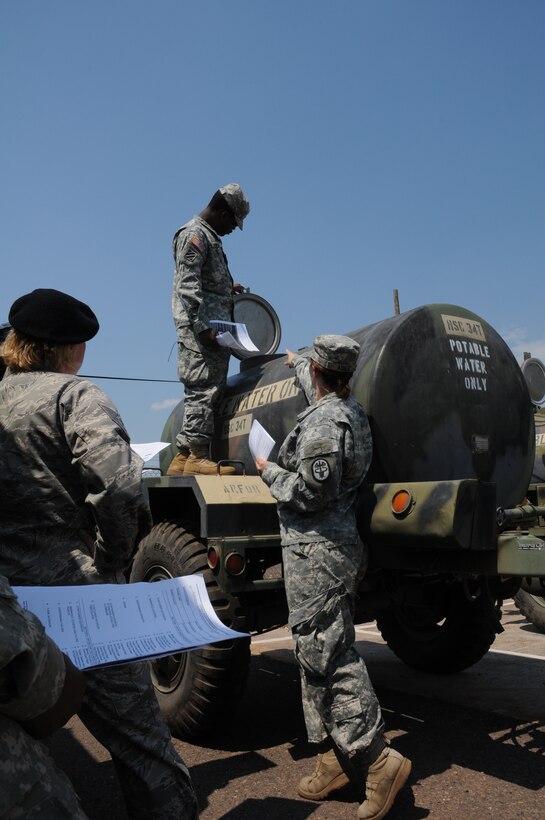 SOTO CANO AIR BASE, Honduras -- Specialist Jamie Asher, Field Sanitation course instructor, reviews  a checklist of items that the class must inspect on the water buffalos during the field portion of the five-day, 40-hour class. Chief Lori Beeman Joint Security Forces Kennel Master, said, “This course is absolutely beneficial for all branches. It’s great to know we’re battle-ready to take care of our Soldiers, Sailors, Airmen and Marines.” (U.S. Air Force photo/Staff Sgt. Kimberly Rae Moore)