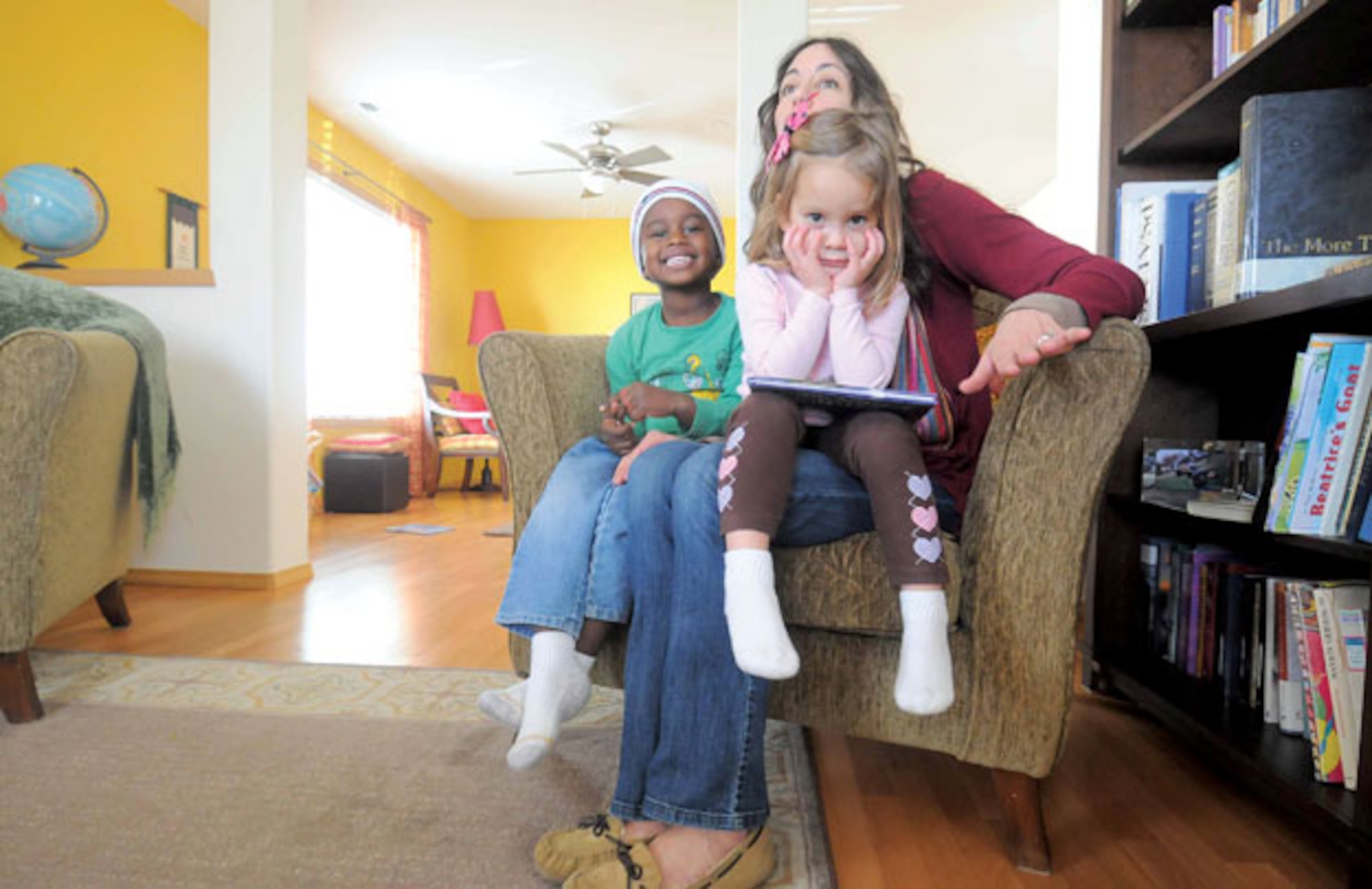 Four-year-old Baruk and sister Kayla, 3, enjoy a moment with mother Heather Jonsson at the family’s DuPont home. Baruk and his 15-month-old brother, Tagen, were adopted from Ethiopia. (U.S. Air Force courtesy photo/J.M. Simpson)