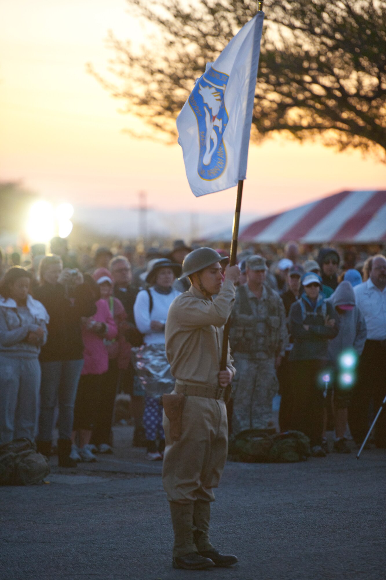 WHITE SANDS MISSILE RANGE, N.M. -- A participant of the 22nd Annual Bataan Memorial Death March holds a flag March 27, 2011 during a moment of silence. Three remaining survivors attended the opening ceremony. The event, attended by a record number of more than 6,000 marchers, commemorates the original Bataan Death March which occurred in the Philippines during World War II. (U.S. Air Force photo by Airman 1st Class Joshua Turner/Released)
