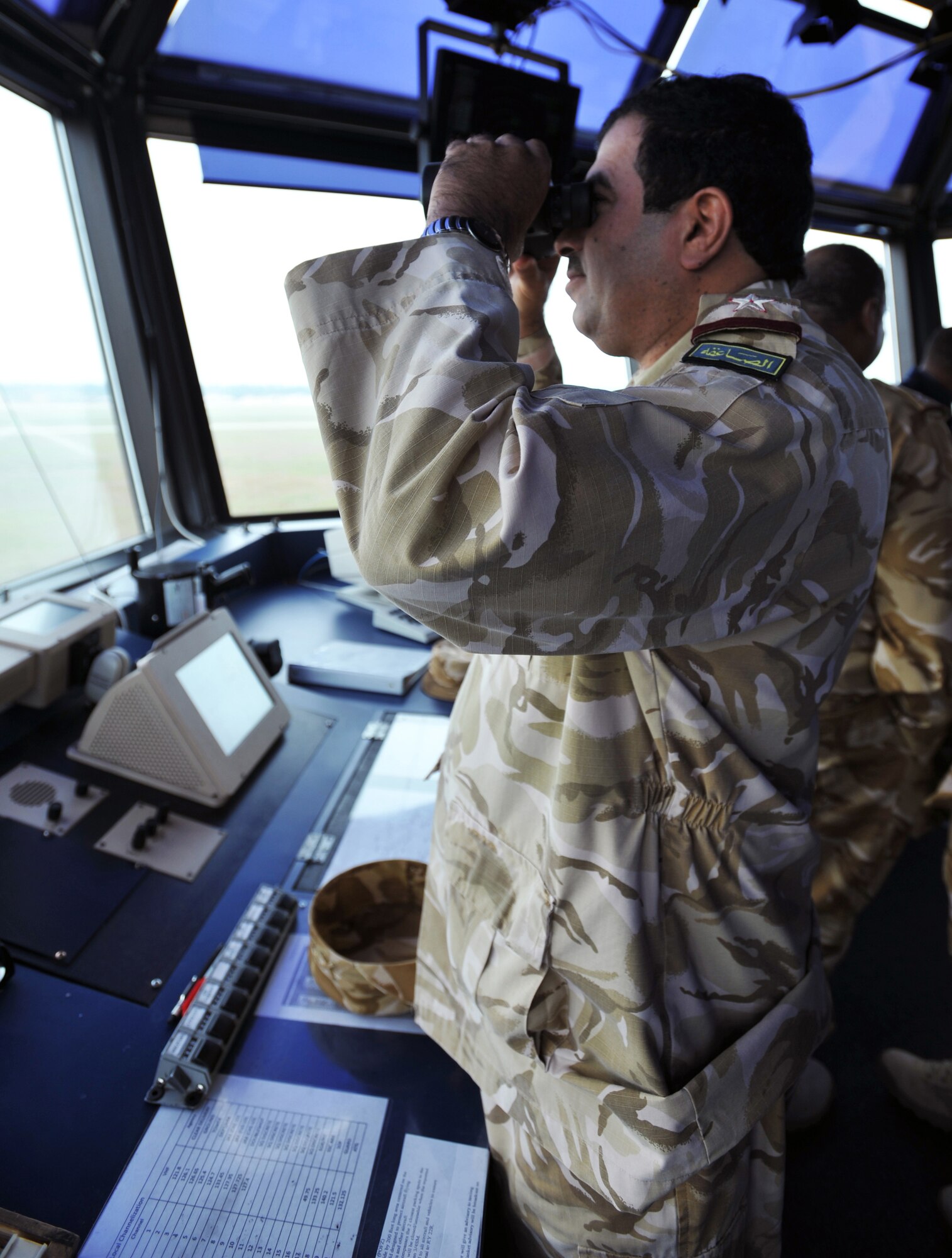 110328-F-NG544-164 SHAW AIR FORCE BASE, S.C.-- Qatari Col. Arhama Mohamed al-Kaabi looks through a pair of binoculars at the air traffic control tower March 28, 2011. Qatar Emiri air force officers toured Shaw to see how the installation does its various missions. (U.S. Air Force photo/ Airman 1st Class Tabatha Duarte (Released)