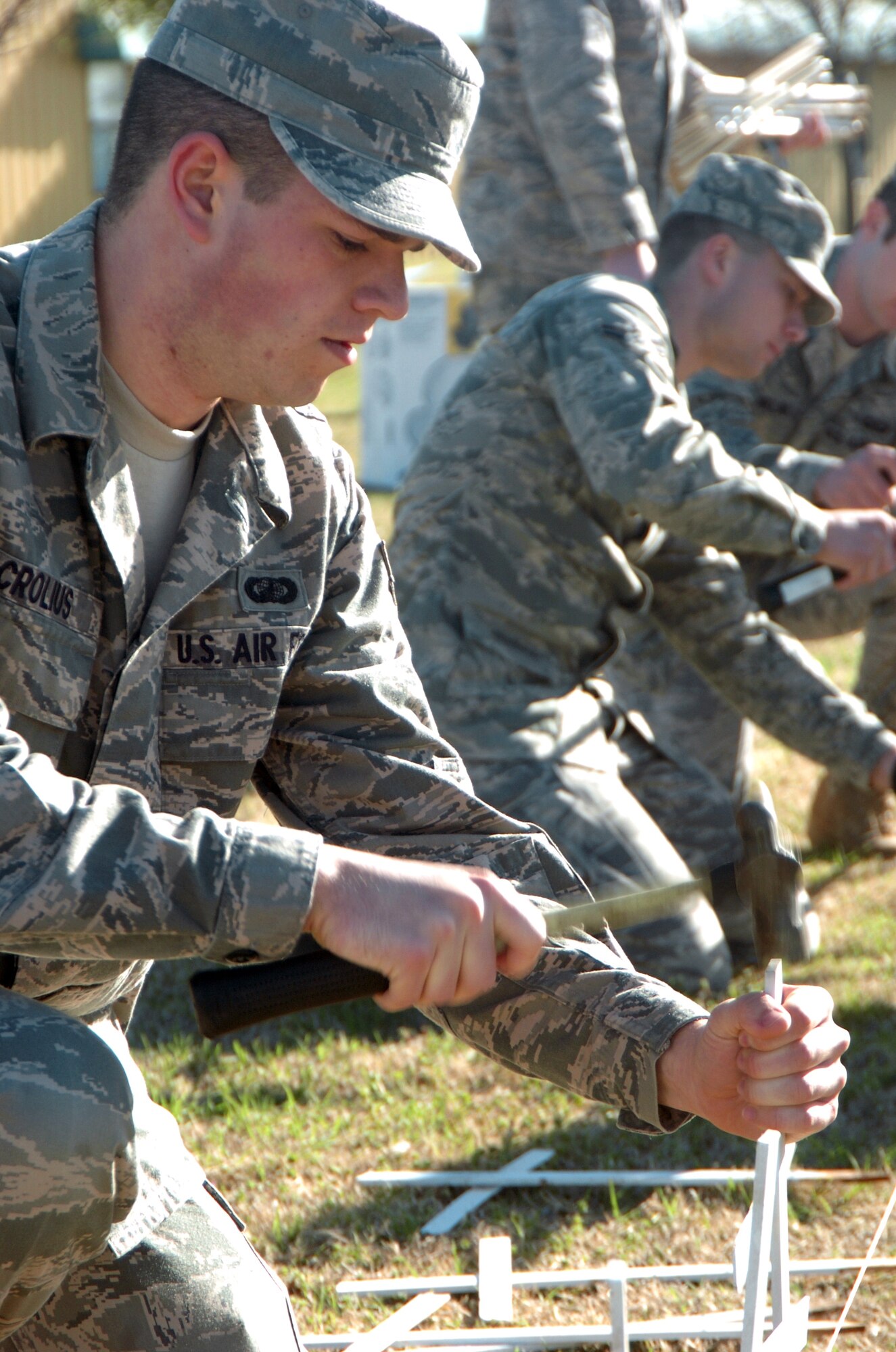 ALTUS AIR FORCE BASE, Okla. - Airman 1st Class Thomas Crolius, 97th Contracting Squadron, carefully hammers in a white cross into the Altus Community Center lawn to represent a life lost to tobacco use.  Airman Crolius was a smoker for 5 years and volunteered to help with the 16th annual Kick Butts Day, a tobacco awareness event for the community. 
(U.S. Air Force photo by Kenny Scarle / Released 97th Air Mobility Wing Public Affairs)