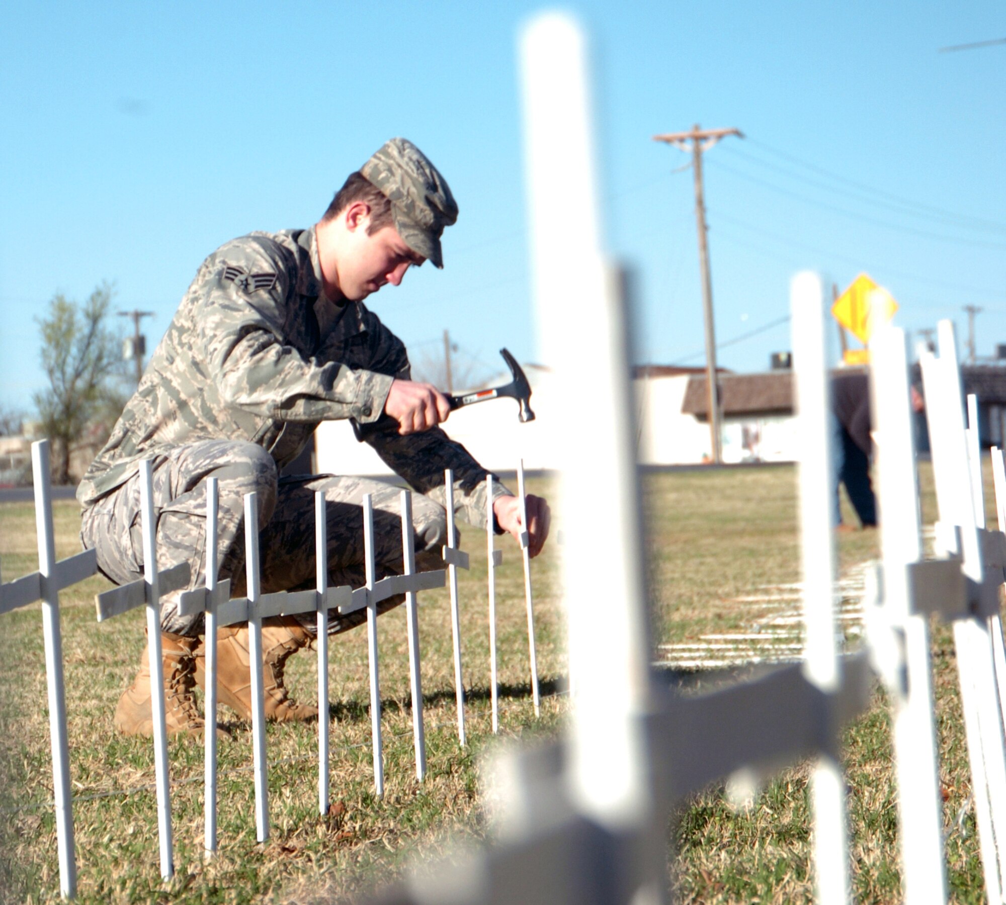 ALTUS AIR FORCE BASE, Okla. -  Senior Airman Carl Franklin, 97th Comptroller Squadron, takes careful aim as he drives in one of the 1200 crosses representing the number of Americans dying daily from tobacco use. Airman Franklin was just one of the Altus Air Force Base Airmen volunteering to help with the 16th annual Kick Butts Day, a tobacco awareness event for the community.
(U.S. Air Force photo by Kenny Scarle / Released 97th Air Mobility Wing Public Affairs)