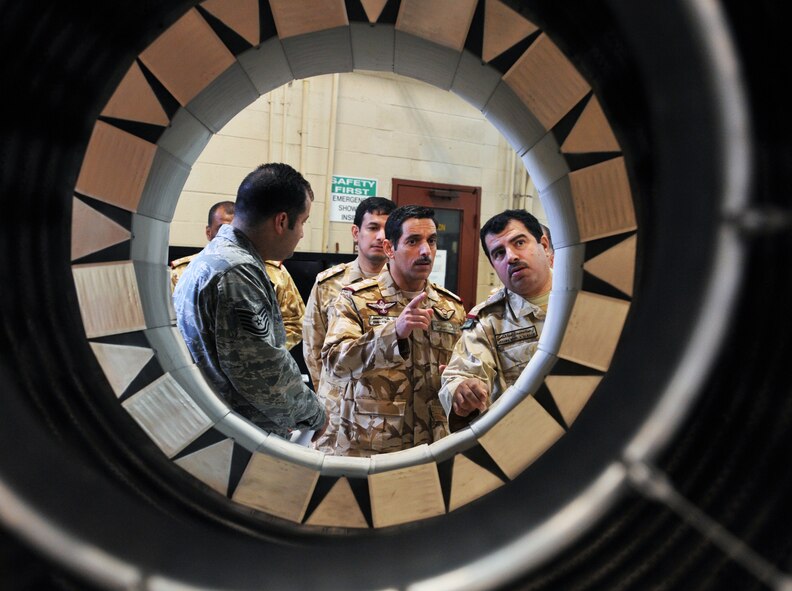 SHAW AIR FORCE BASE, S.C. -- Tech. Sgt. Domingo Muniz, 20th Component Maintenance Squadron aerospace propulsion craftsman, shows Qatari air force officers an augmenter for an F-16 jet engine March 28, 2011. Qatar Emiri air force officers toured Shaw Air Force Base, S.C., to see how the installation does its various missions. (U.S. Air Force photo/Airman 1st Class Tabatha Duarte) 