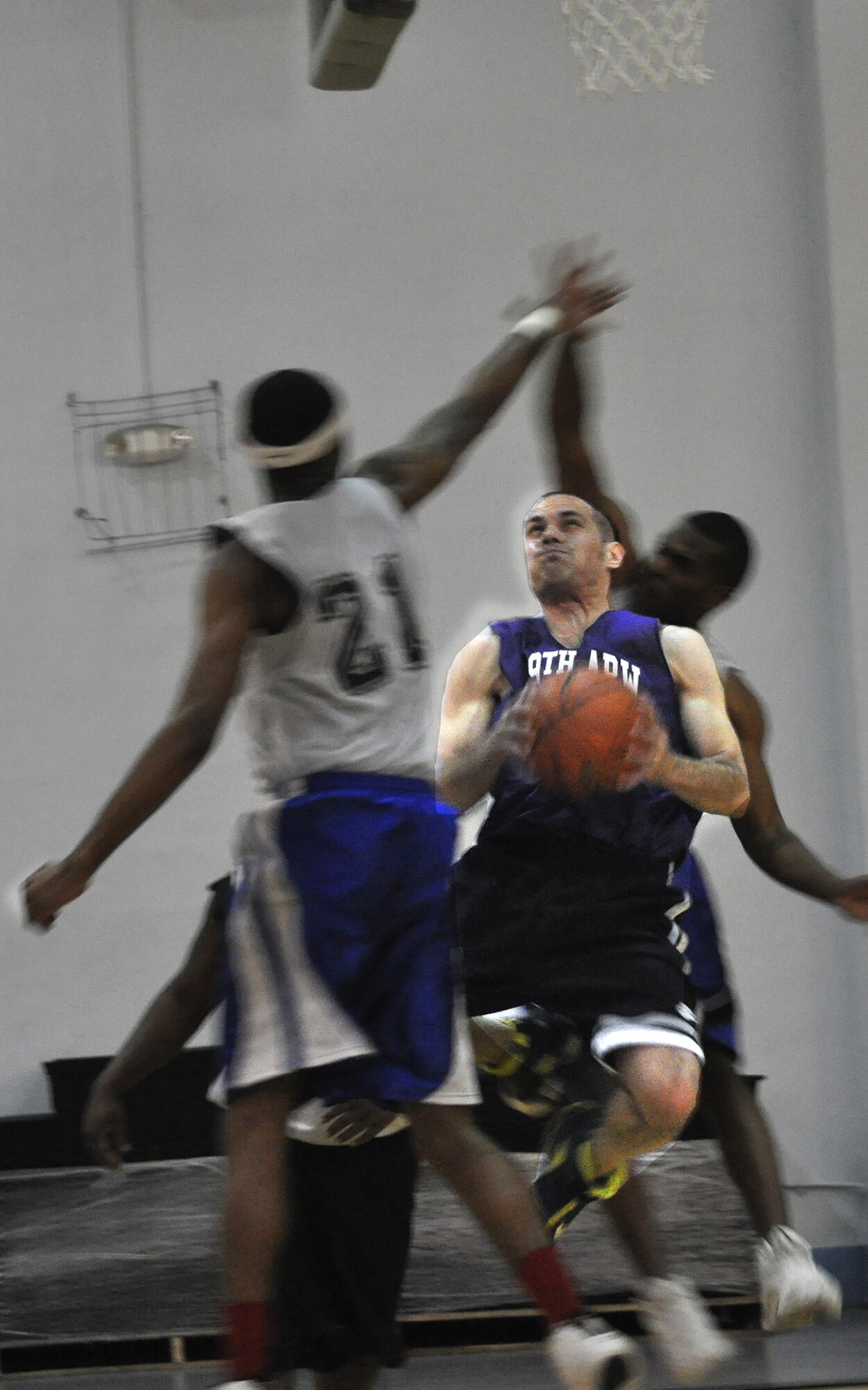 JOINT BASE ANDREWS, Md. -- 459th Air Refueling Wing basketball team member, Antonio Delvalle, attempts a two-point shot against the 11th Civil Engineering Squadron defense at the East Fitness Center here March 28. The 459 ARW played the 11 CES in a final championship game after winning their regular 2010-2011 season conference. (U.S. Air Force photo illustration/Tech. Sgt. Steve Lewis)
