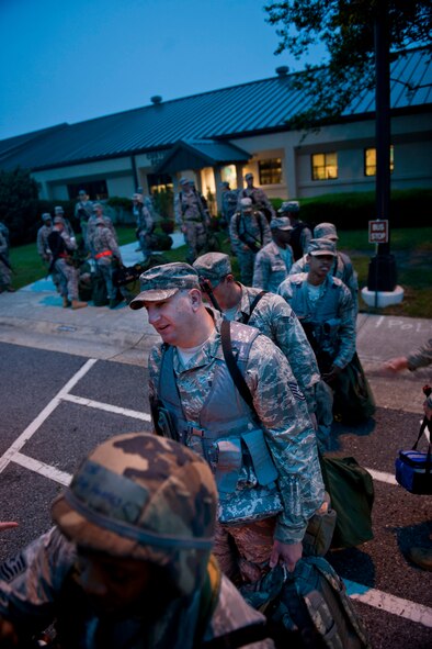 Members of the 23rd Civil Engineer Squadron line up to board a transportation bus en route to an exercise entry point March 30 at Moody Air Force Base, Ga. With many participants in the exercise, it took multiple buses to get all members of the unit to the EEP. (U.S. Air Force photo/Staff Sgt. Jamal D. Sutter)(RELEASED)