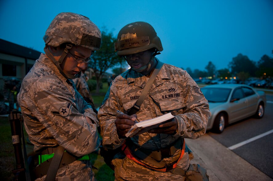 Airman Lucas McCorkel, 23rd Civil Engineer Squadron electrical power production apprentice, and Staff Sgt. Johnny Carter, 23rd CES electrical power production craftsman, review power layouts in preparation for an operational readiness exercise March 30 at Moody Air Force Base, Ga. The layouts were for a field training exercise site where the two would be working. (U.S. Air Force photo/Staff Sgt. Jamal D. Sutter)(RELEASED)