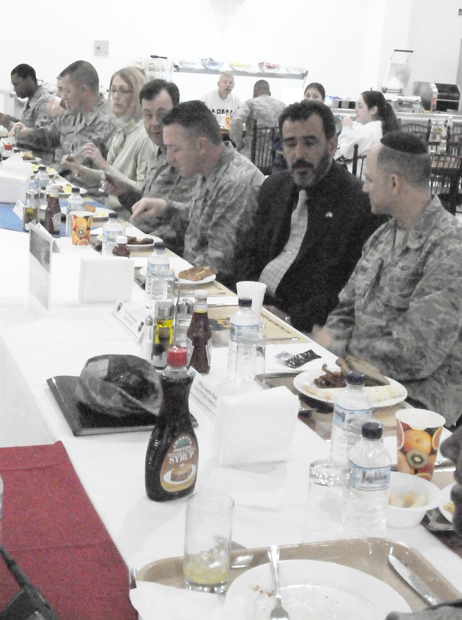 Chaplain (Col.) Brett Oxman, U.S. Air Forces Central Command chaplain, as well as 386th Air Expeditionary Wing leadership and distinguished guest enjoy breakfast at the Desert Winds Dining Facility March 17. The breakfast was the first part of the Rock Chapel's National Prayer Breakfast which began at the dining facility and migrated to the Rock Chapel. (U.S Air Force photo by Staff Sgt. Patrice Clarke)