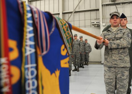 Master Sgt. Randall Fontenot salutes with the guidon during the 437th Airlift Wing Change of Command ceremony March 29 on Joint Base Charleston, S.C. Master Sergeant Fontenot is the 437th Operations Support Squadron first sergeant. (U.S. Air Force photo/Staff Sgt. Katie Gieratz)