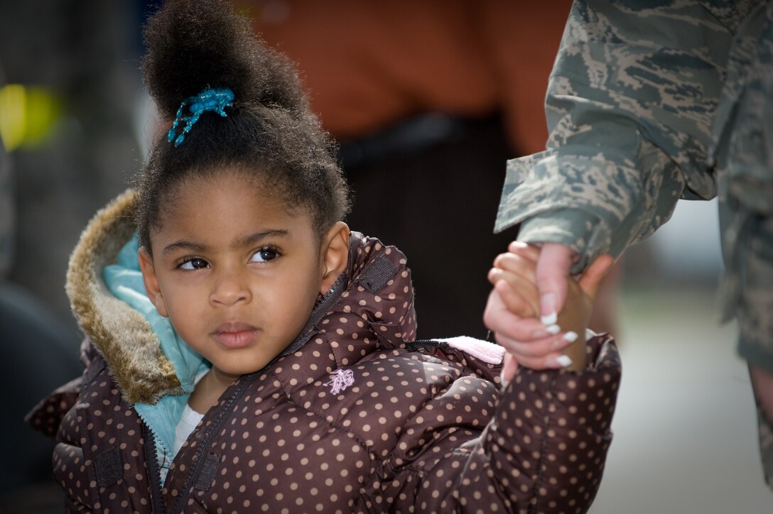 An Airman helps a child from a chartered aircraft that arrived from Japan, March 25, 2011, at Travis Air Force Base, Calif. Following the earthquake and tsunami that hit Japan on March 11, hundreds of family members from military bases in Japan voluntarily relocated to the U.S. ( U.S. Air Force photo/Ken Wright) 