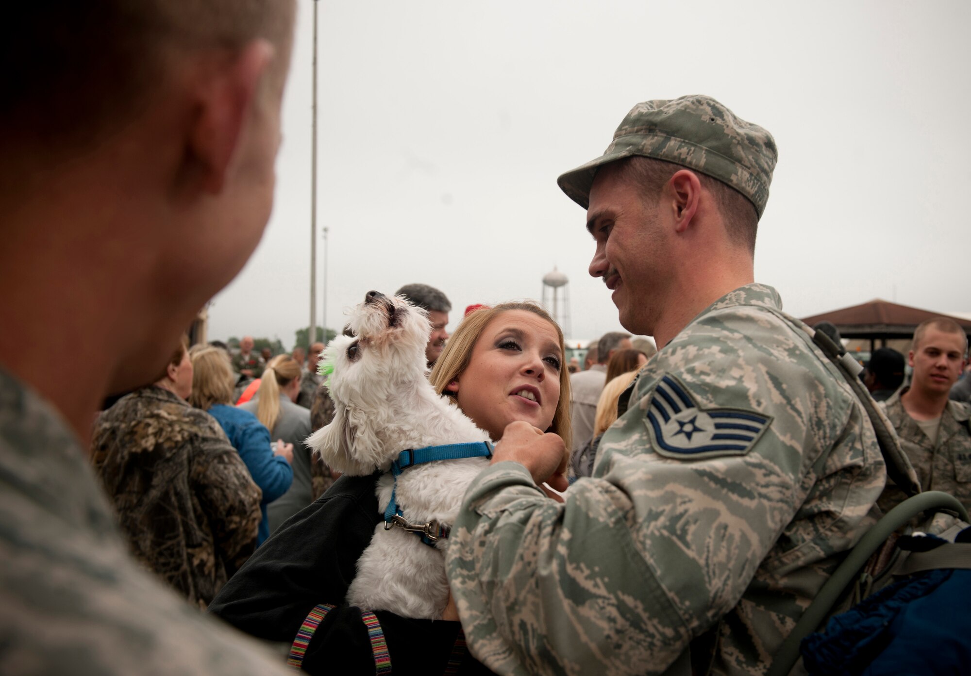 Tundra, a puppy that belongs to Nicholas Bahler and wife Mallory, joins in on a welcome-home celebration by barking and howling at the sky at Moody Air Force Base, Ga., March 29. Mrs. Bahler said she was excited to see her husband return from a six-month deployment to Kandahar, Afghanistan. (U.S. Air Force photo/Airman 1st Class Joshua Green)(RELEASED)
